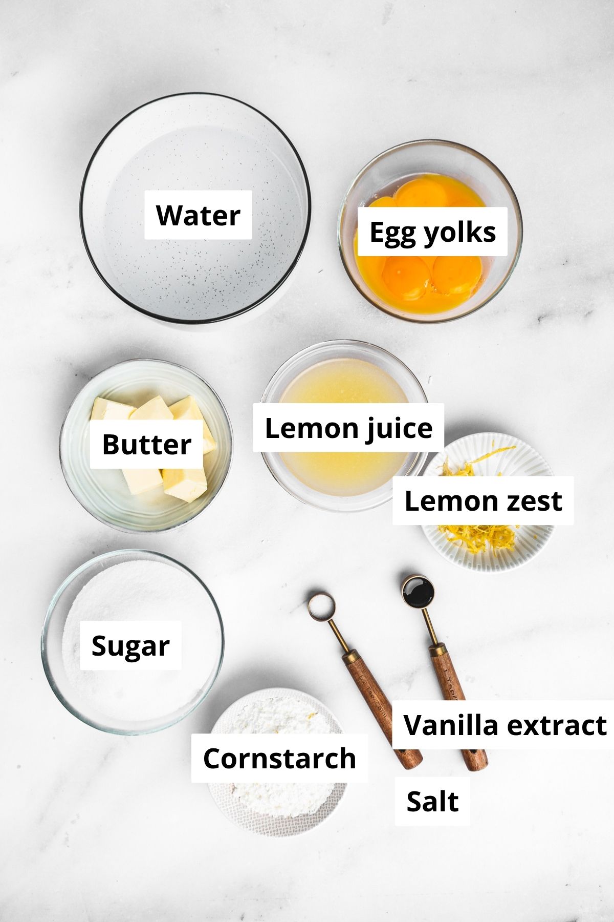 ingredients for lemon meringue pie filling in bowls on a kitchen counter
