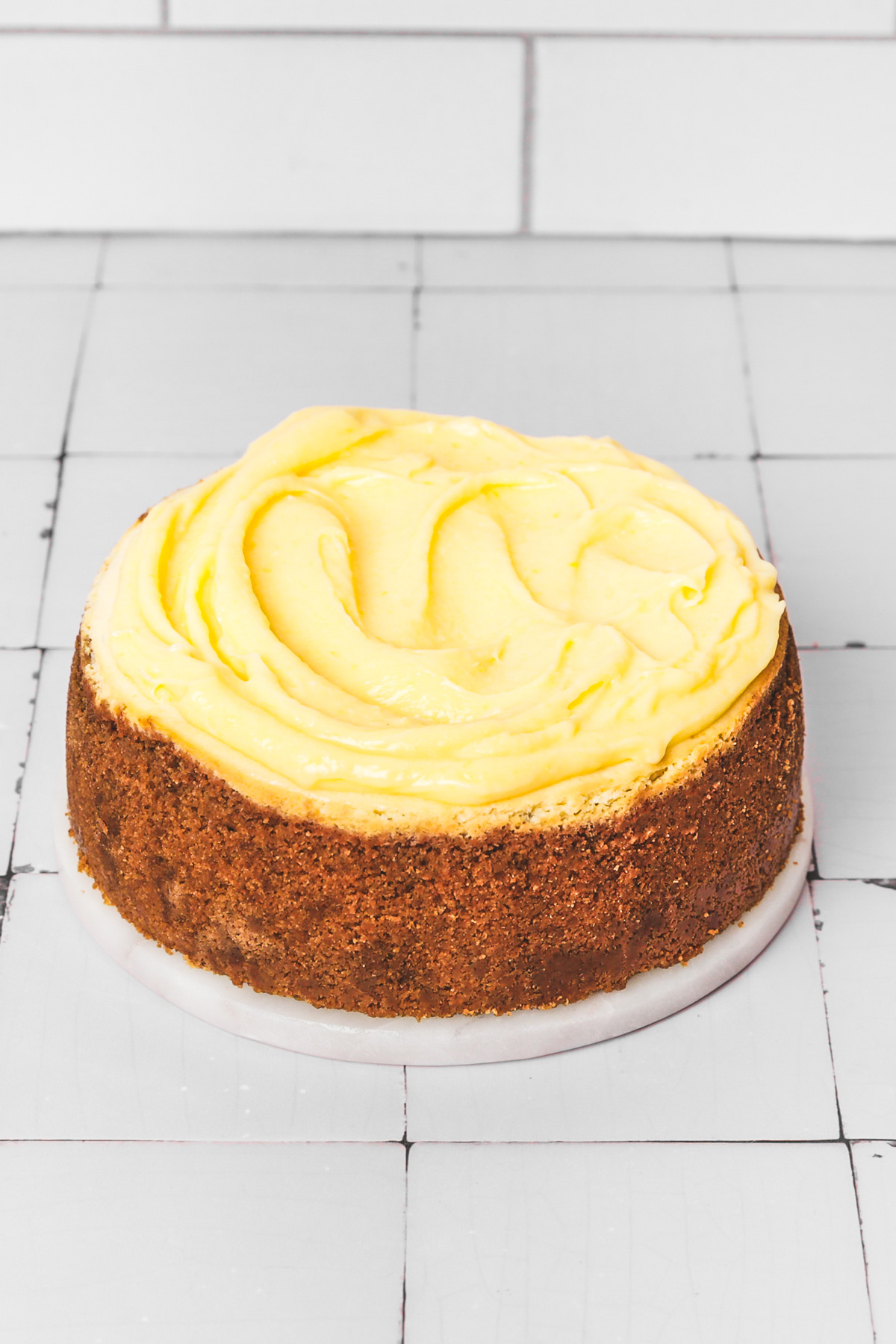 Lemon cheesecake topped with homemade lemon curd on a table