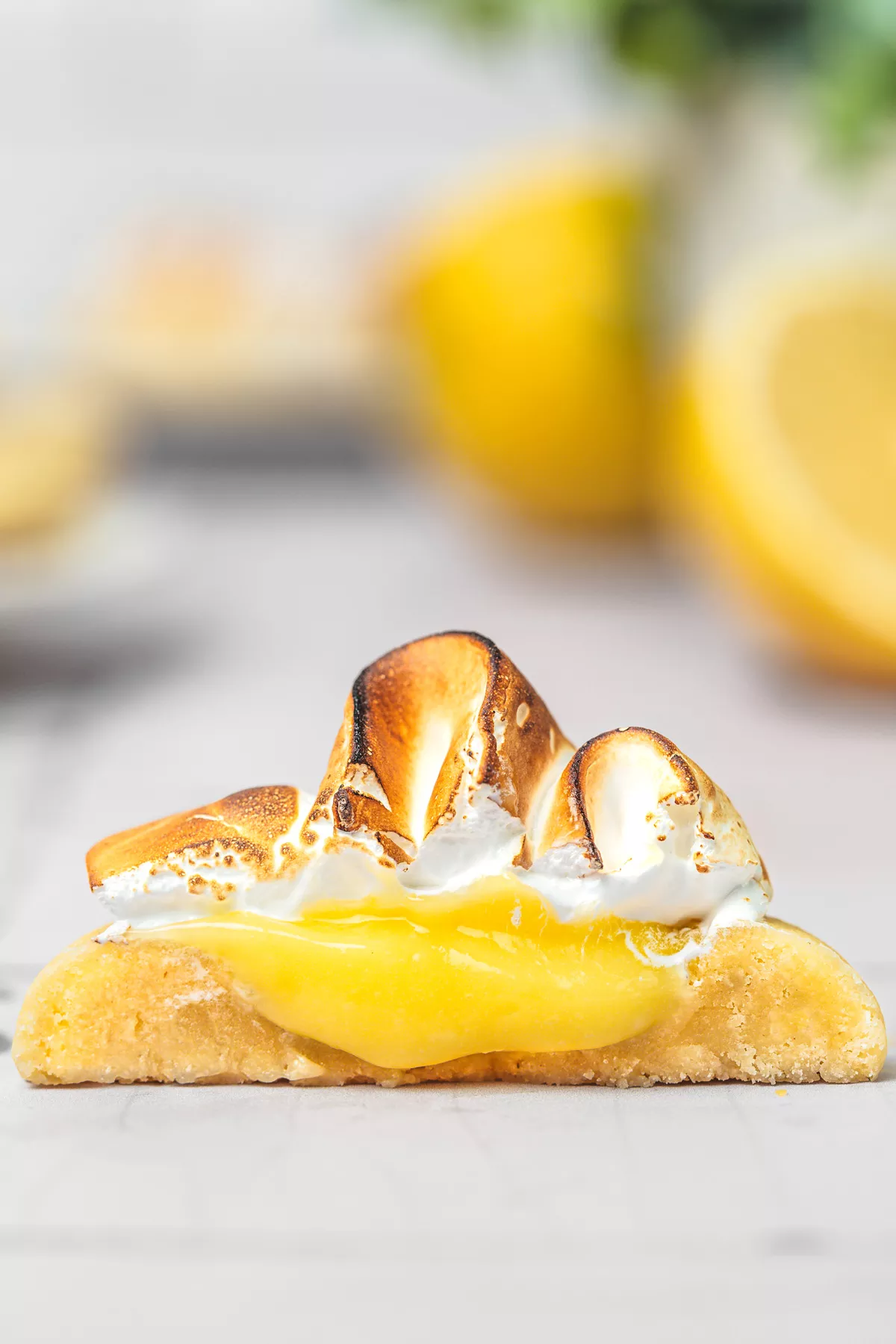 close-up of lemon meringue cookies with lemon filling and meringue on a serving plate