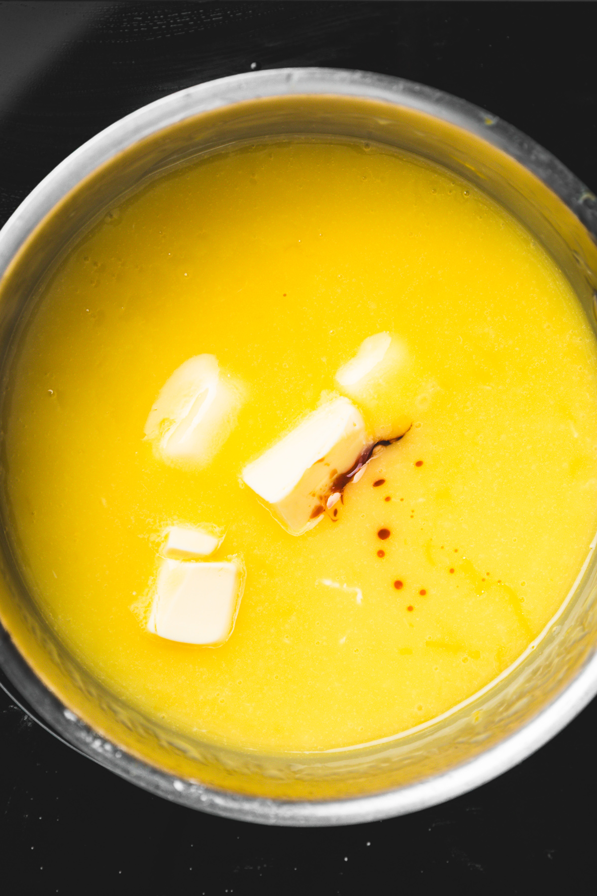 lemon pie filling in a pan with butter melting