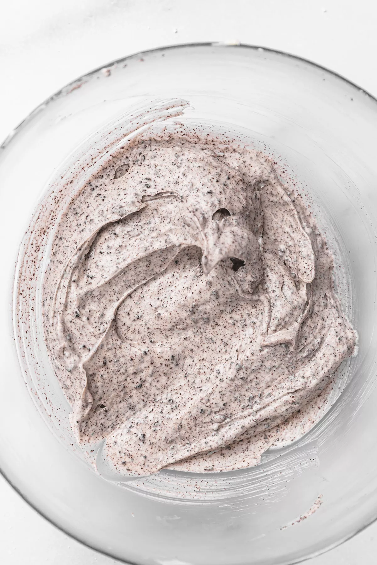 Bowl of fluffy cream cheese glaze for Oreo cinnamon rolls