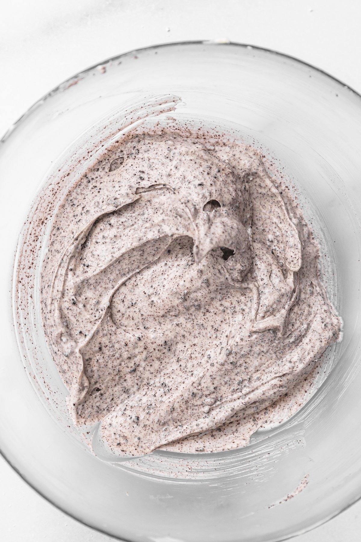Bowl of fluffy cream cheese glaze for Oreo cinnamon rolls
