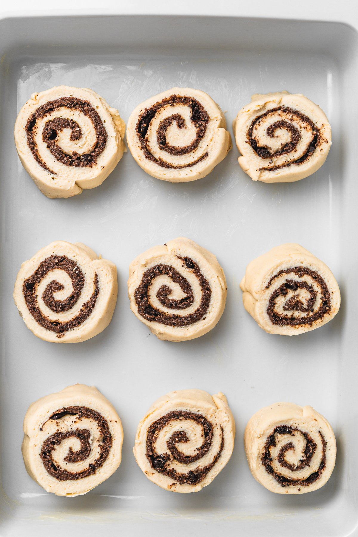 Rolled Oreo cinnamon rolls before baking, placed in a baking dish