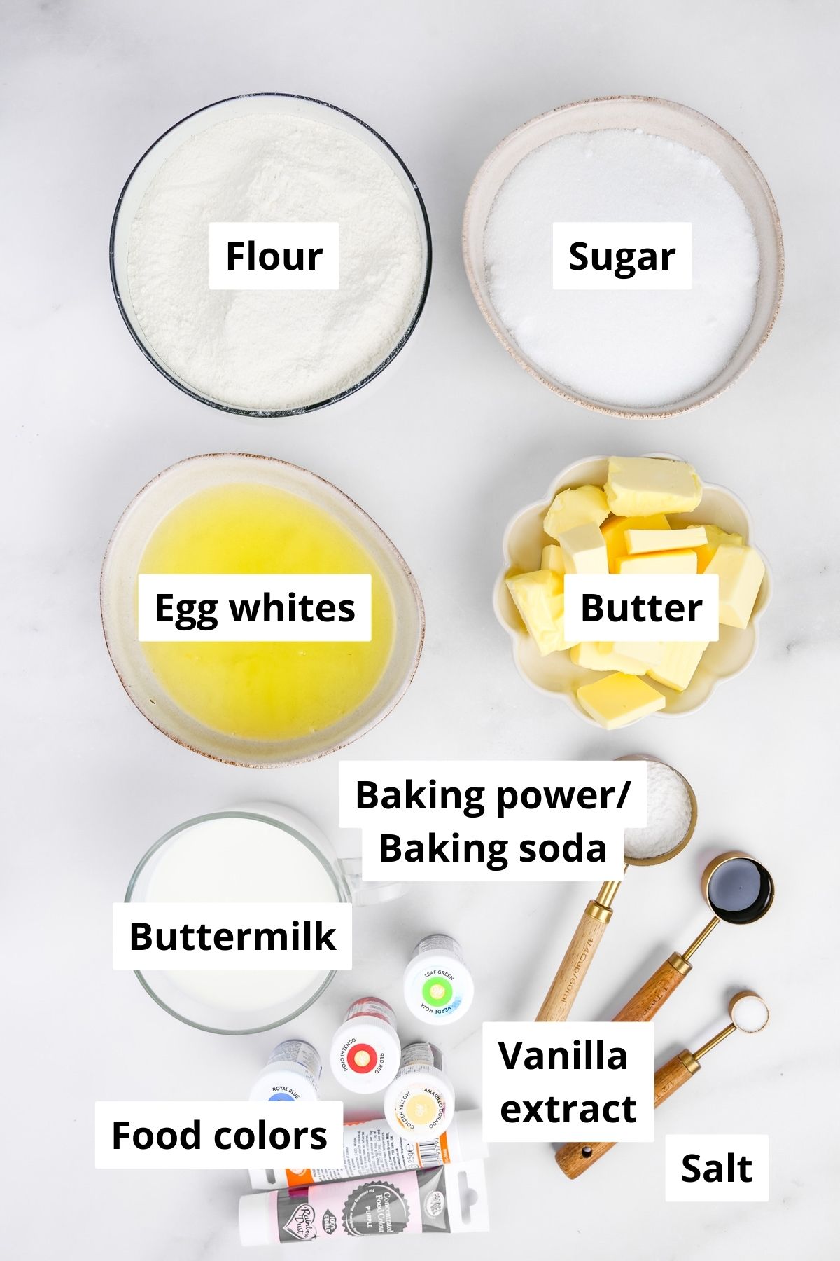 Ingredients for homemade rainbow cake with flour, butter, sugar, eggs and food coloring