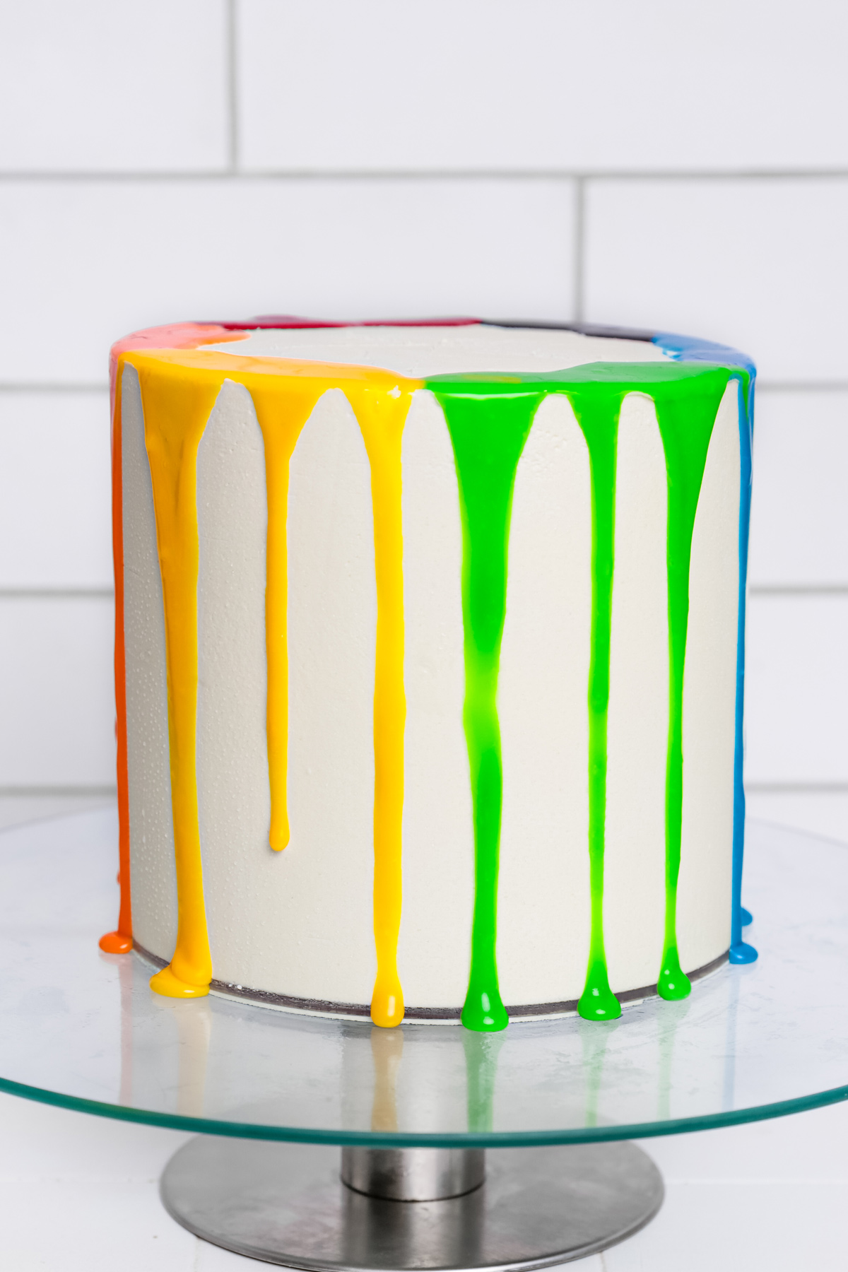 Rainbow cake with colorful drip and buttercream frosting