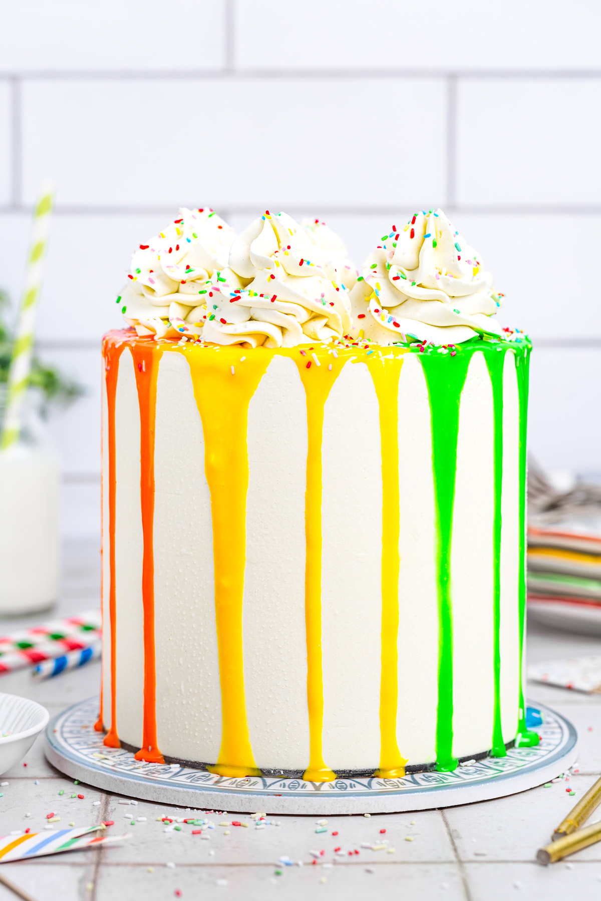 Rainbow layer cake on a cake stand ready to serve