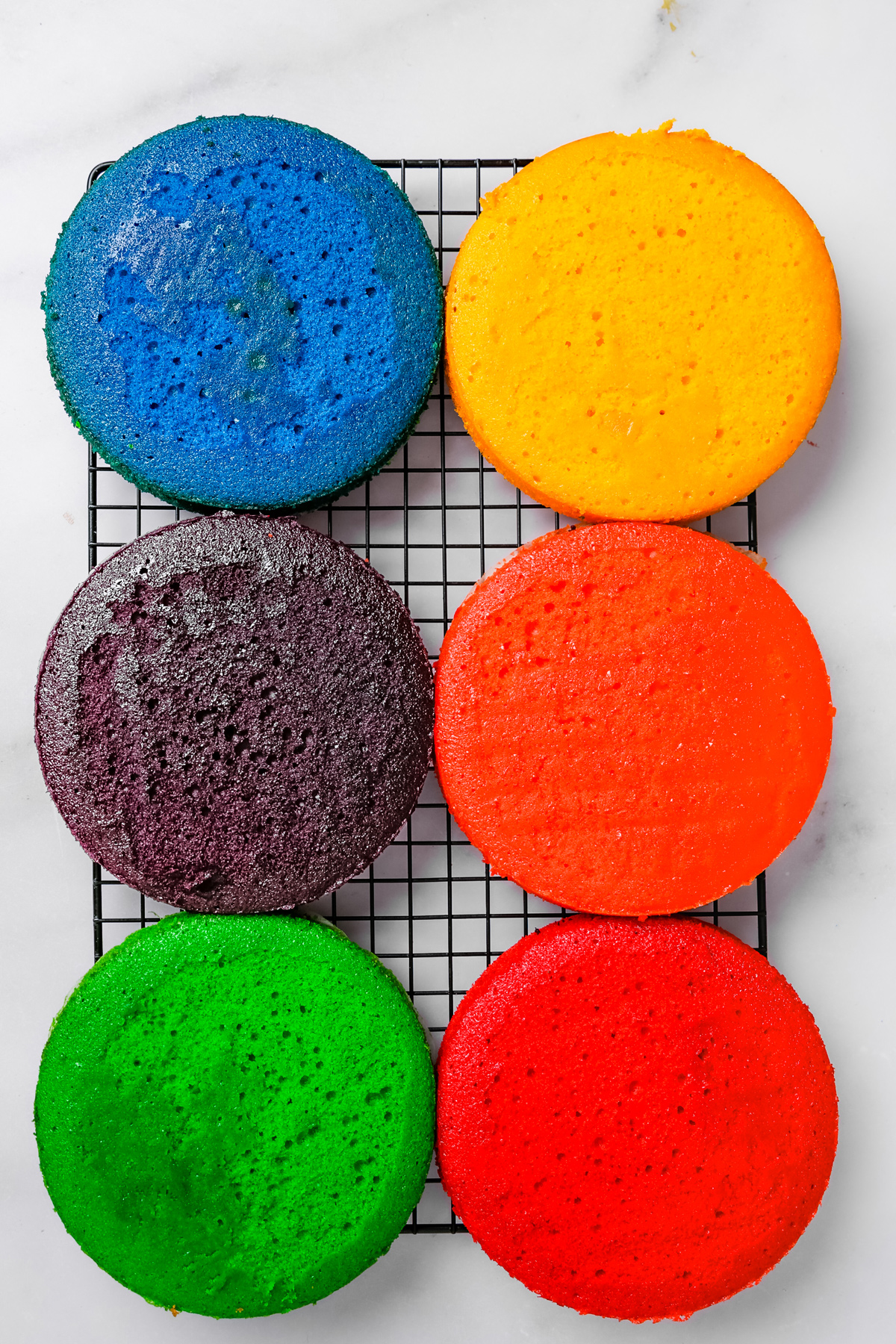 Cooling rack with rainbow cake layers for assembly