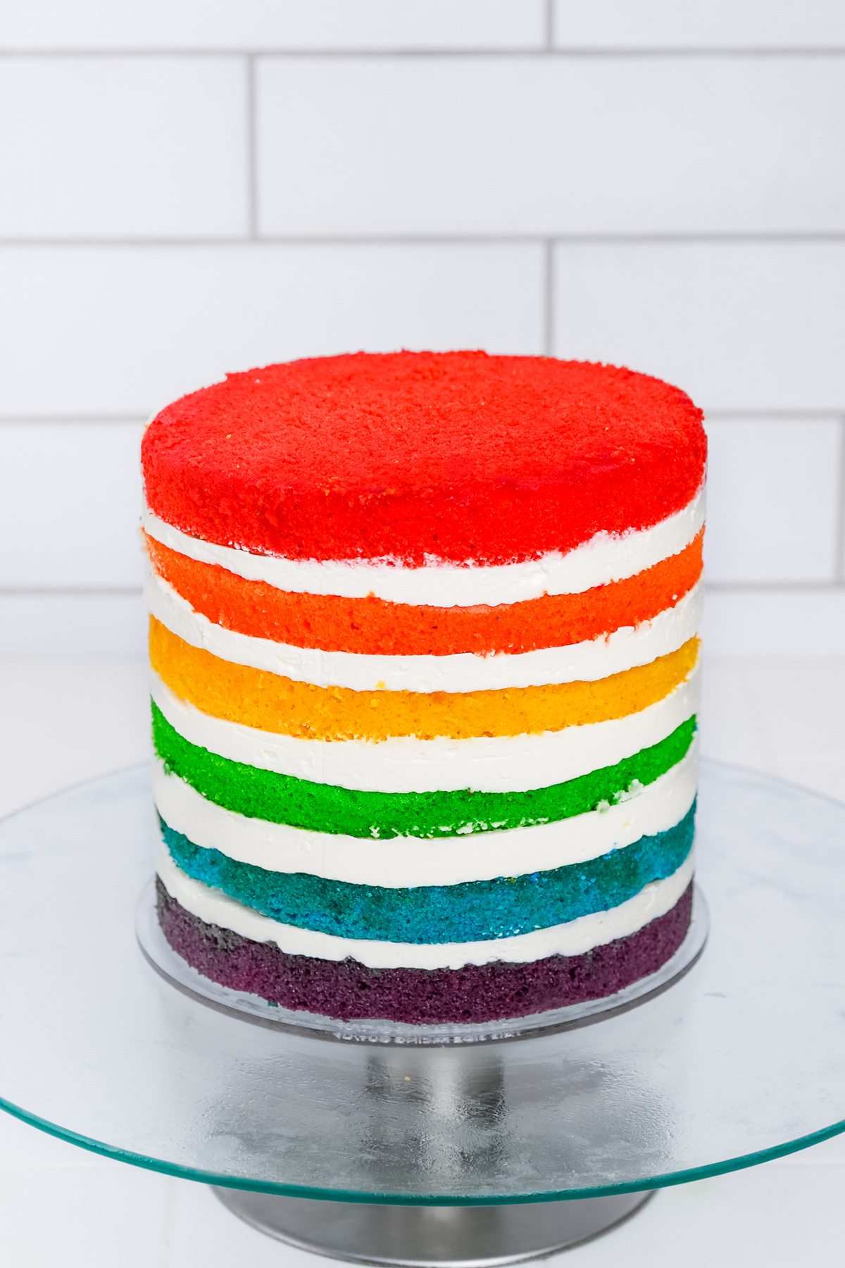 Rainbow layer cake assembled without frosting