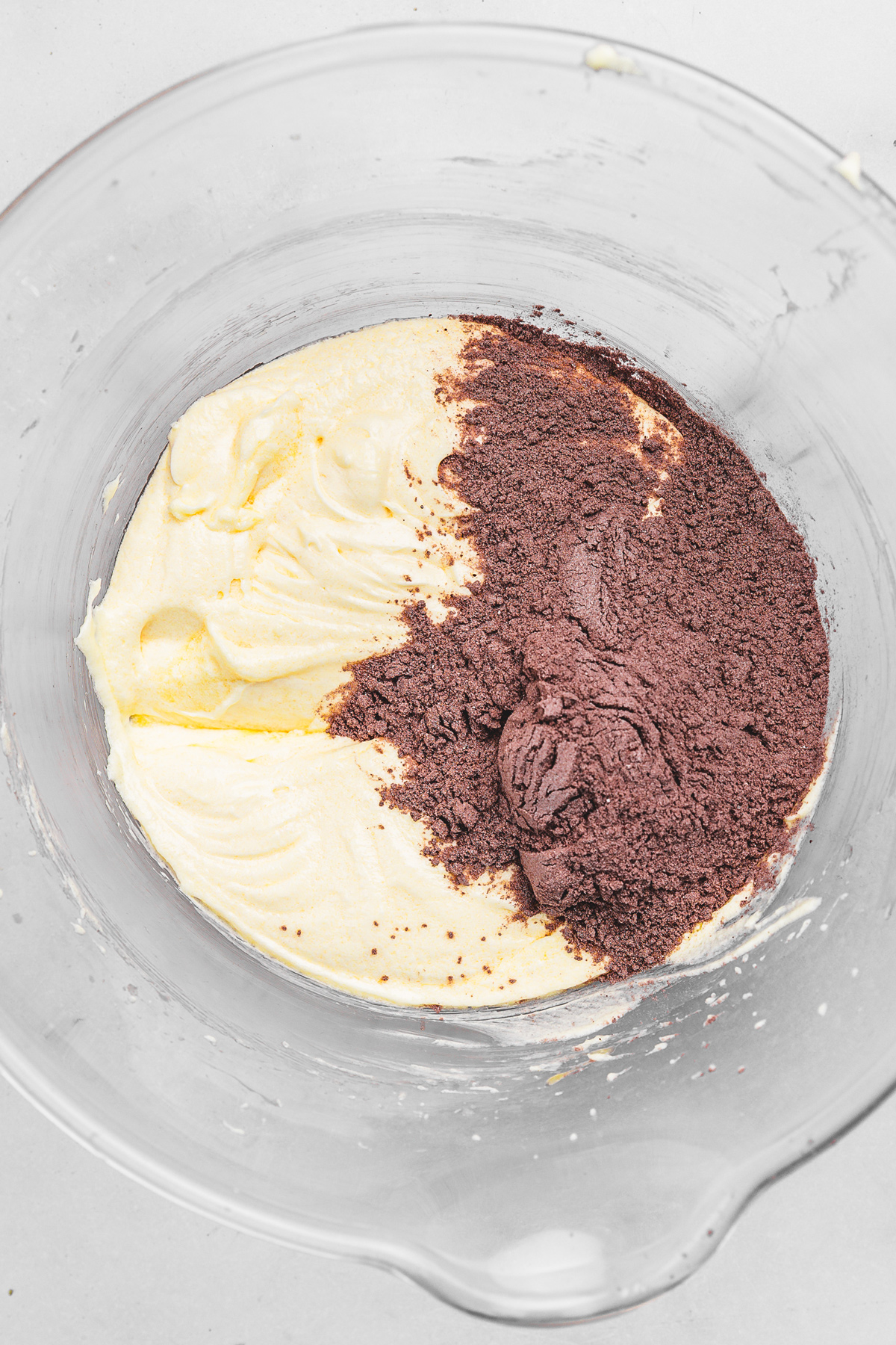 Chocolate cupcake batter with cocoa powder and dry ingredients in a bowl