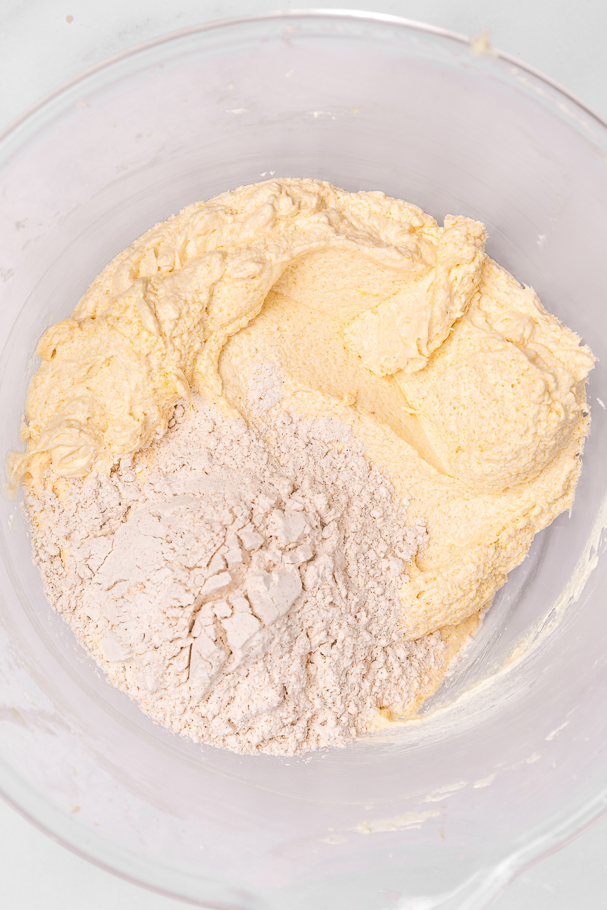 Cinnamon cake batter mixed with flour in a bowl