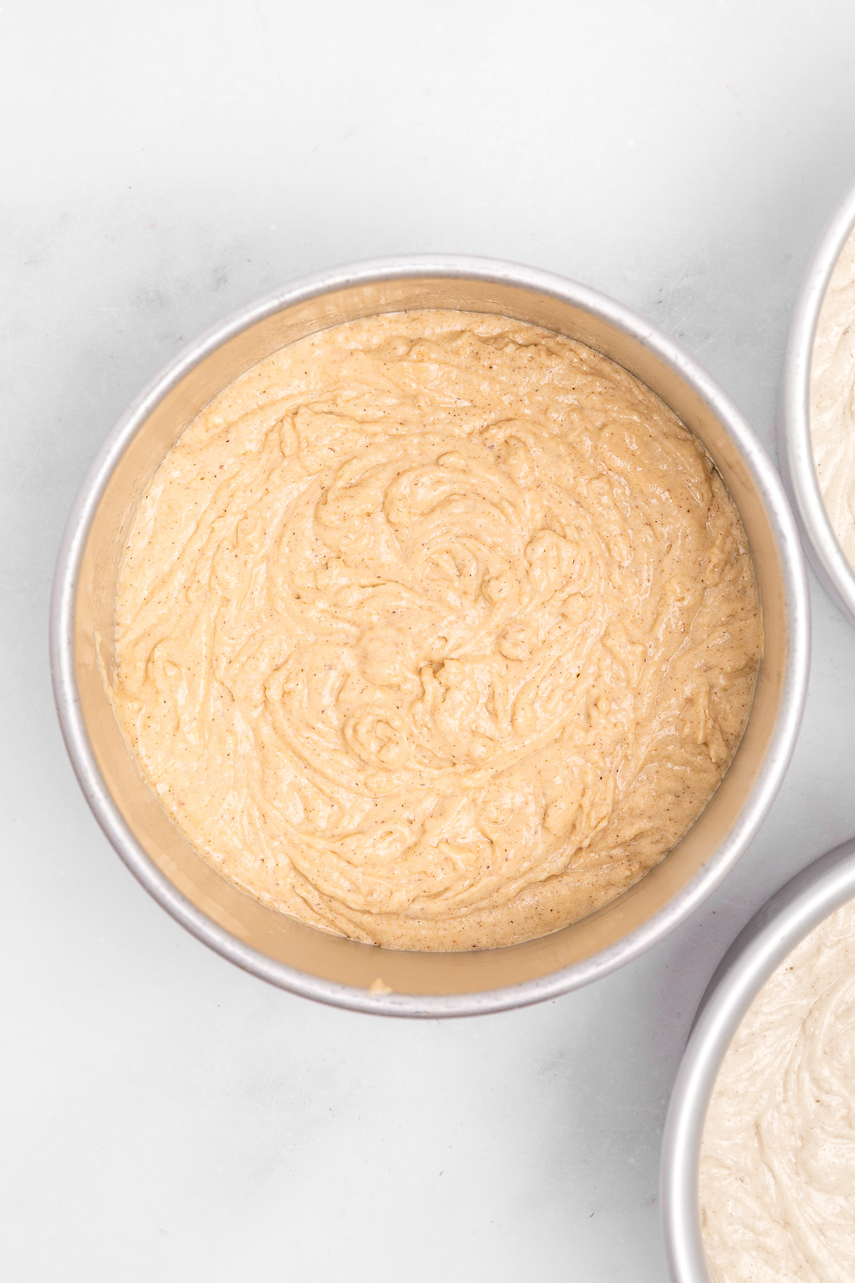 Cake pan filled with cinnamon cake batter before baking