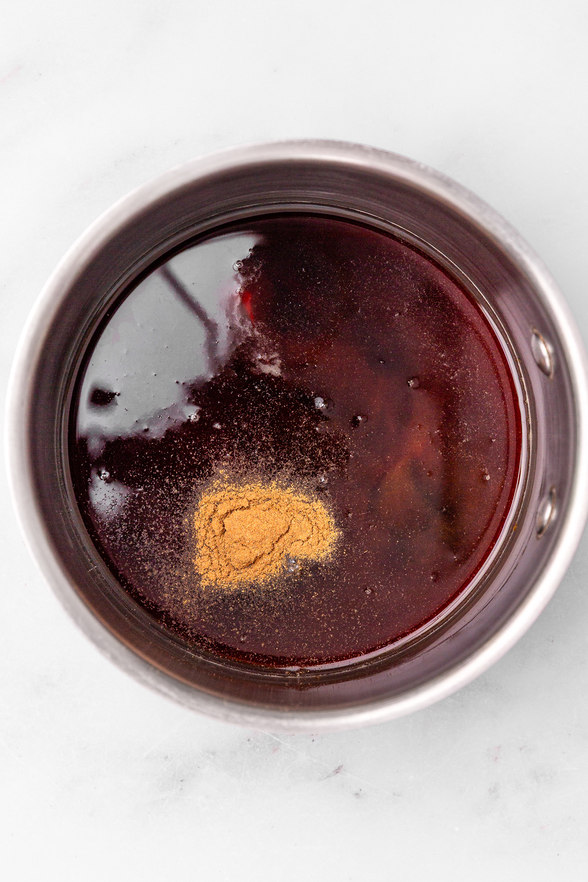 Saucepan with ingredients to make cinnamon syrup