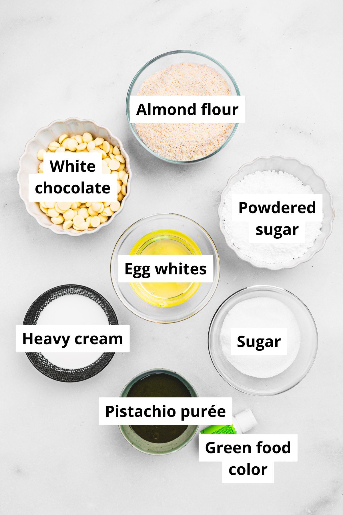 Ingredients for pistachio macarons including almond flour, sugar, egg whites, and pistachio paste