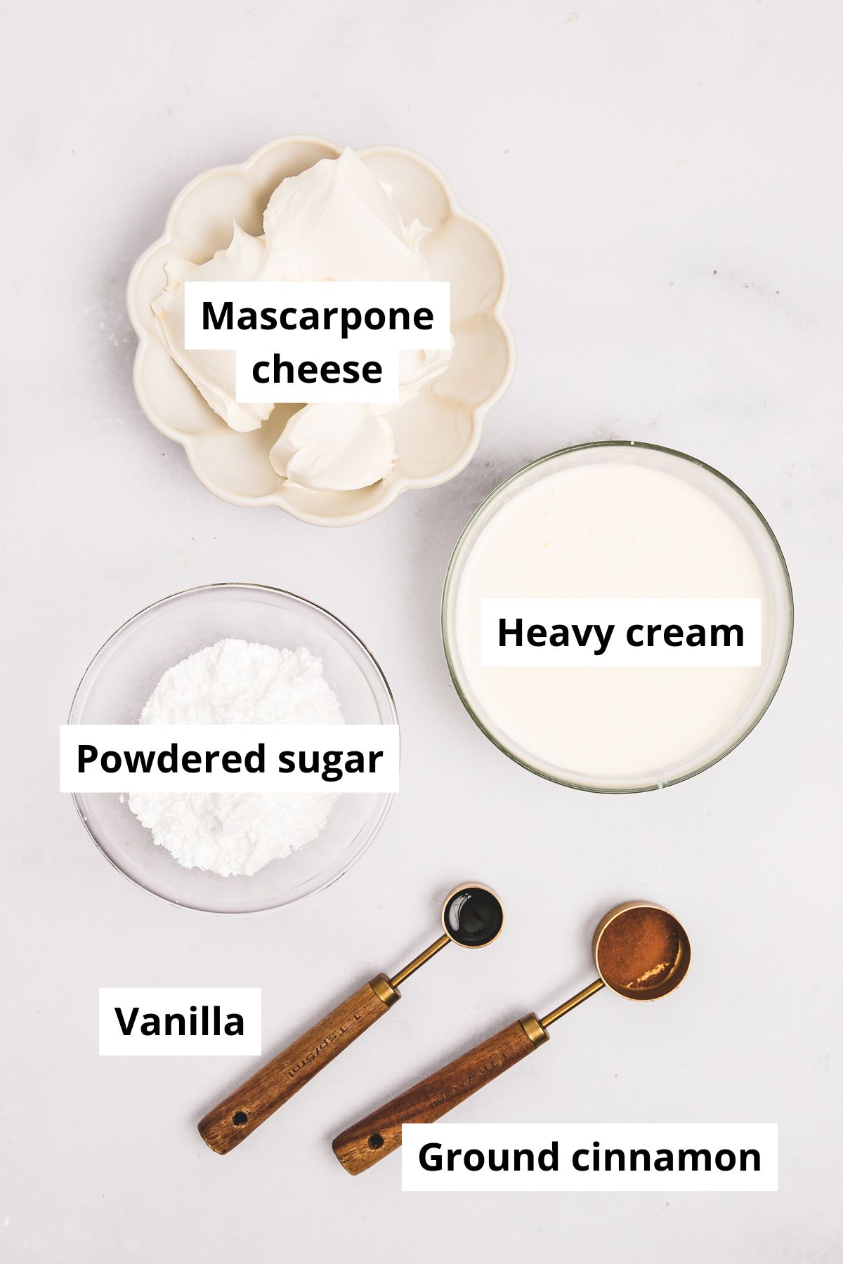 Ingredients in bowls for cinnamon mascarpone whipped cream
