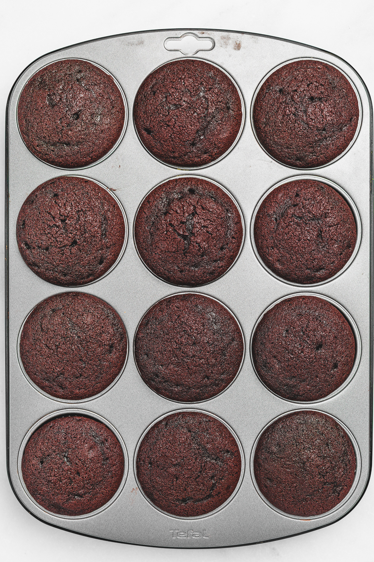 Cupcake pan with baked Dubai chocolate cupcakes