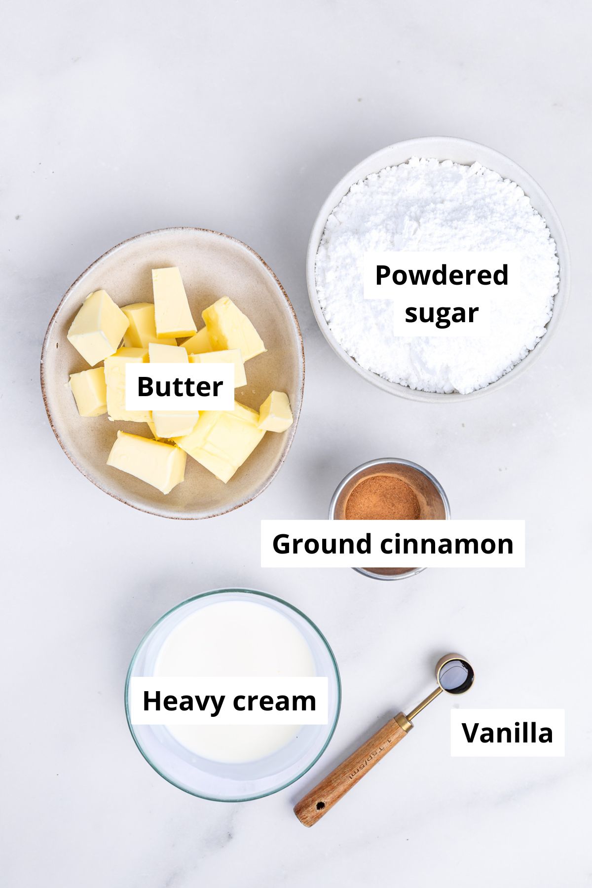 Bowls with ingredients to make cinnamon buttercream frosting