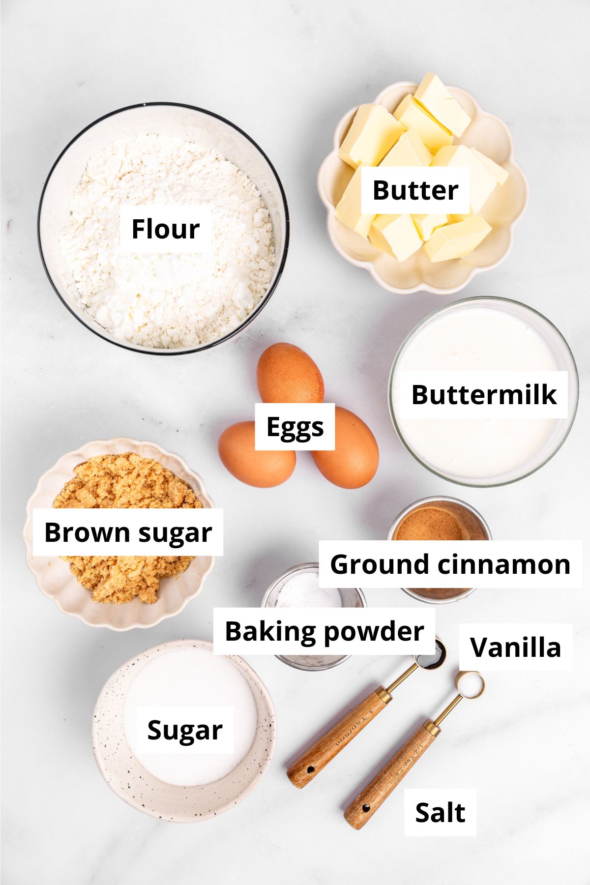 Bowls with ingredients to make cinnamon roll cake