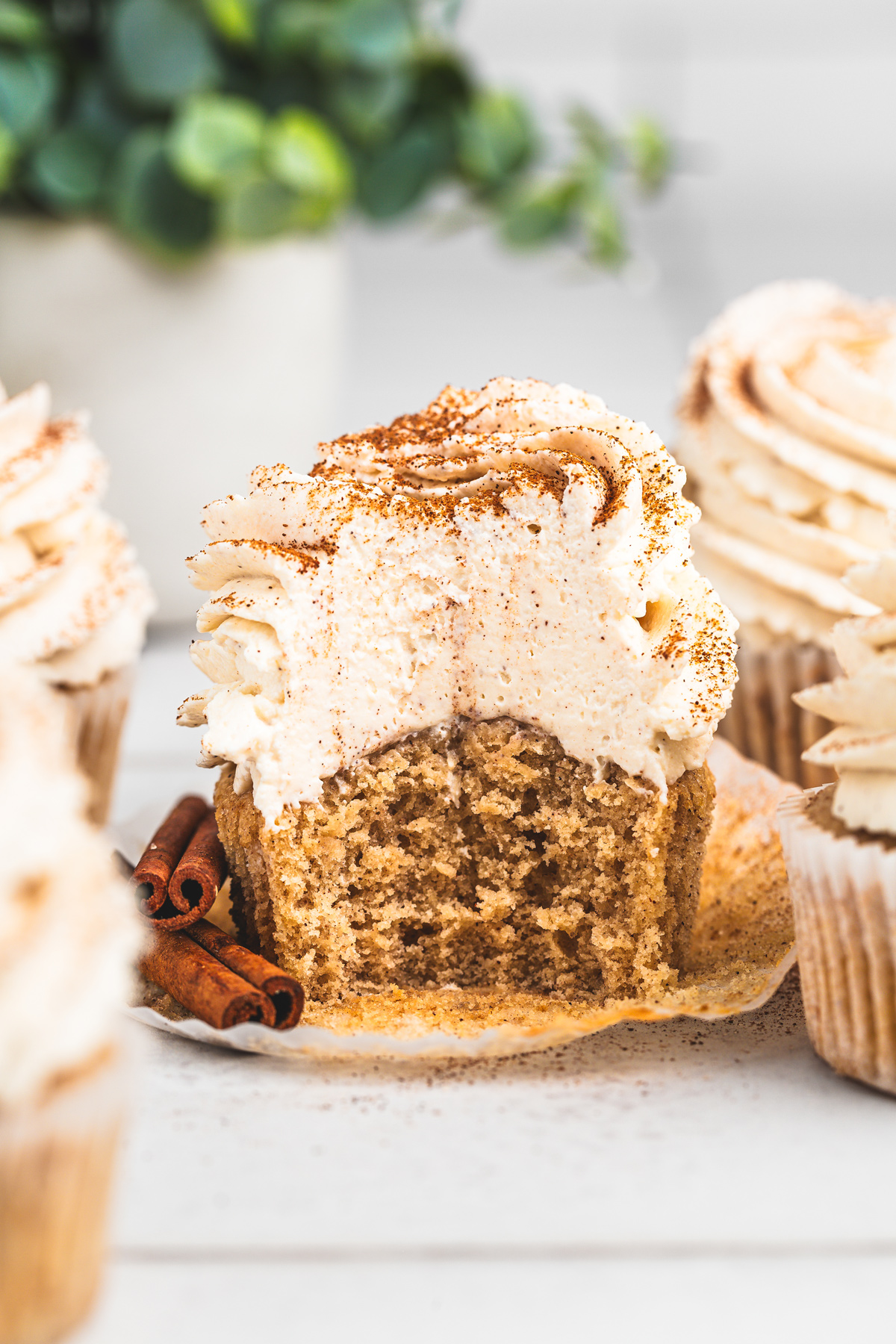 Cinnamon cupcakes topped with mascarpone frosting on a table