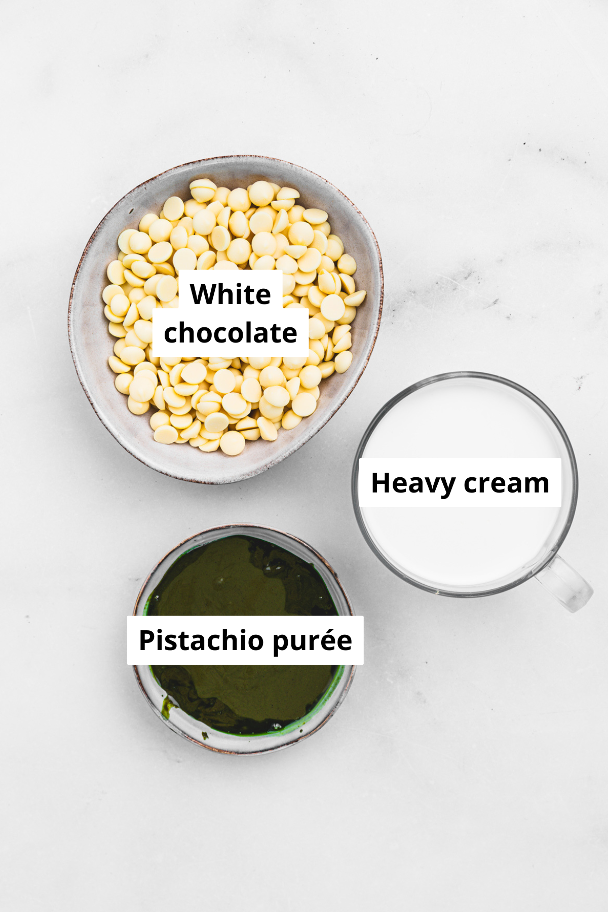 Ingredients for pistachio ganache including white chocolate, heavy cream, and pistachio paste