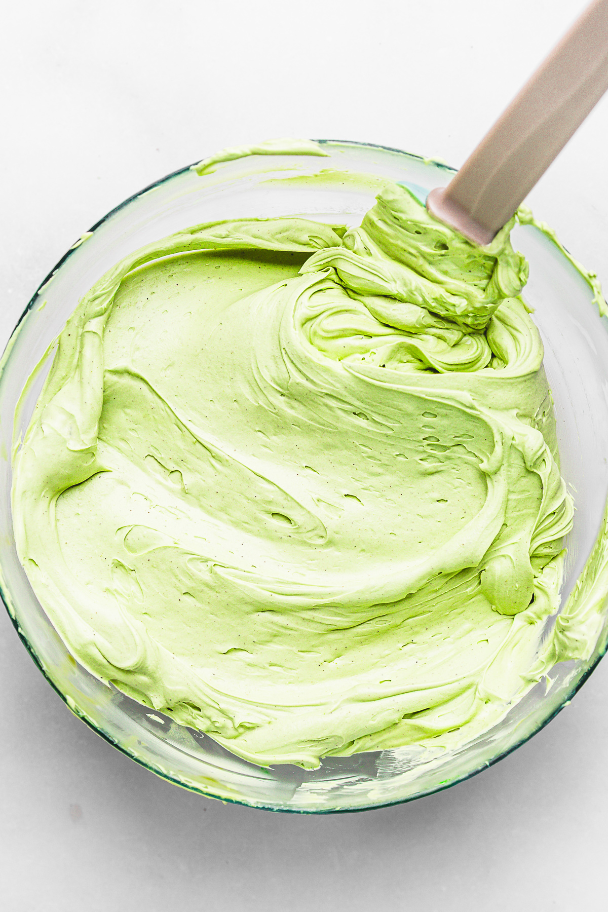 Whipped pistachio ganache in a mixing bowl, ready to fill macarons