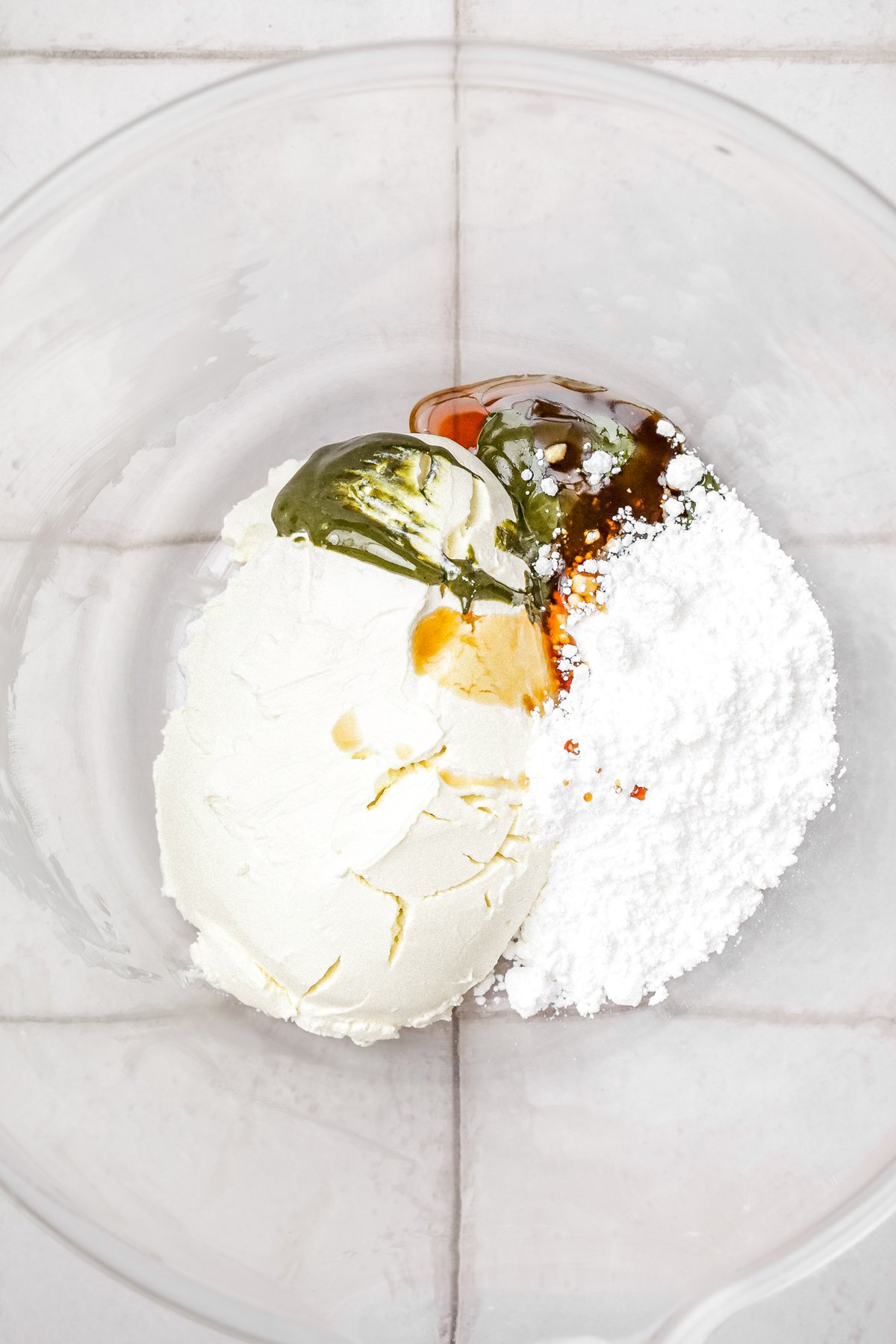 bowl with mascarpone, powdered sugar, vanilla extract, and pistachio paste for pistachio frosting