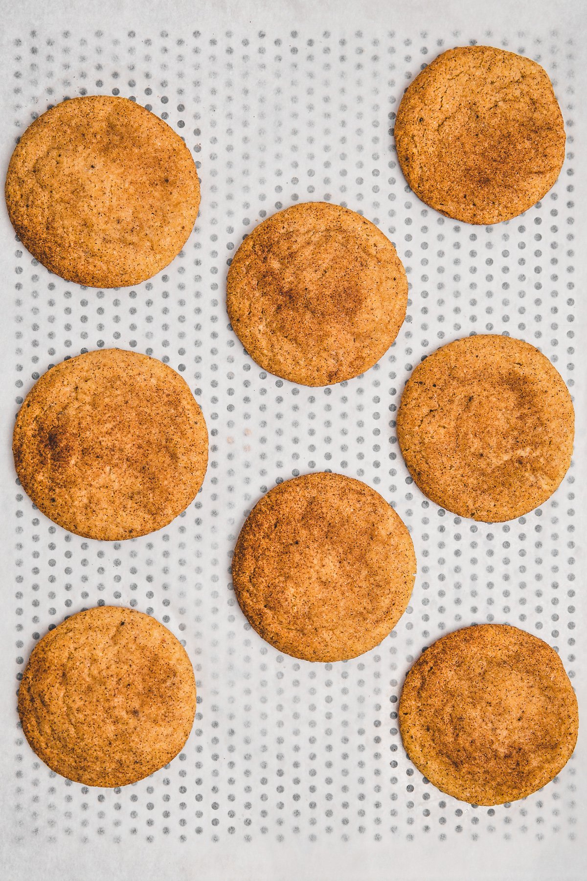 Freshly baked brown butter snickerdoodle cookies on a baking tray