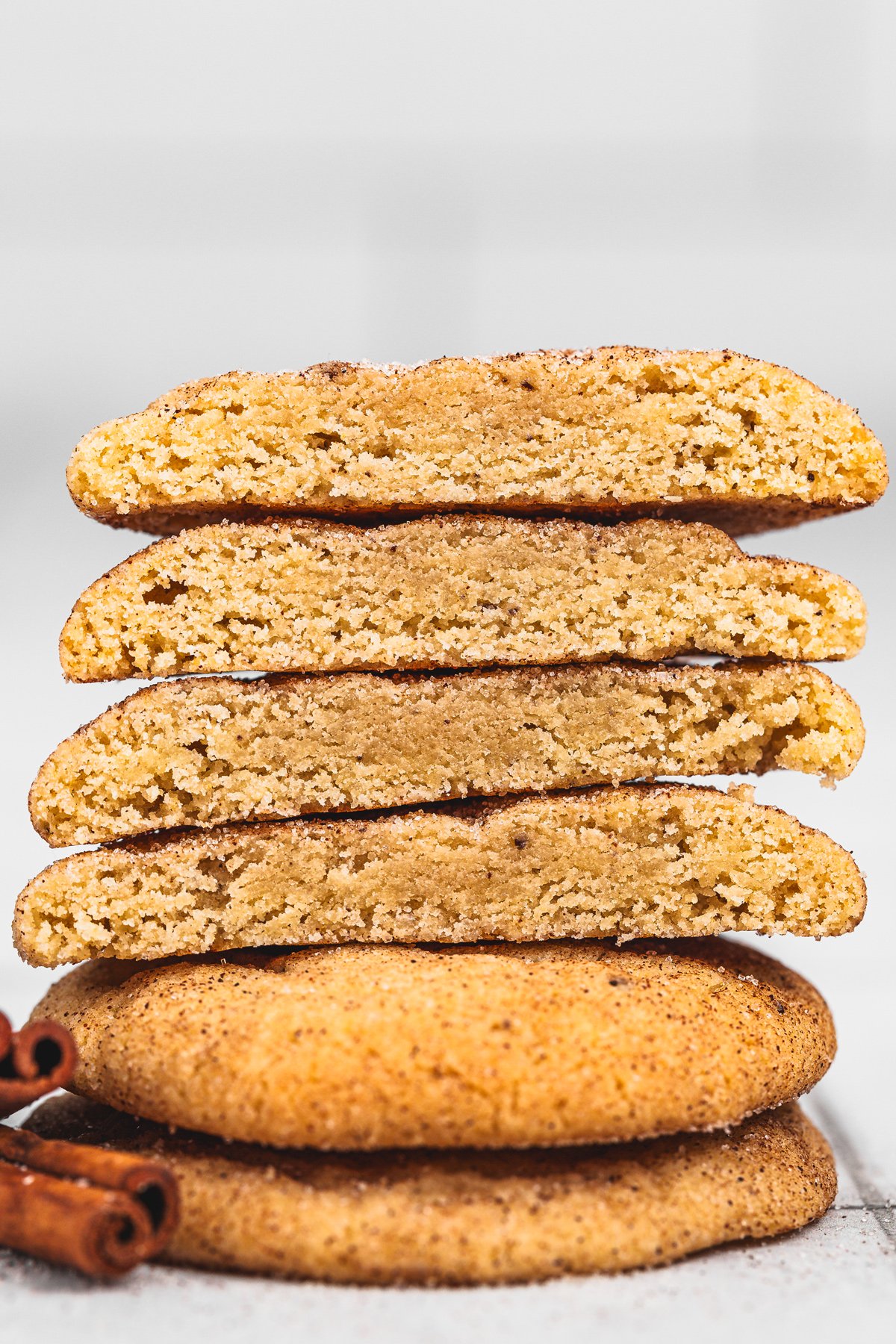 Chewy snickerdoodles broken in half showing inside texture