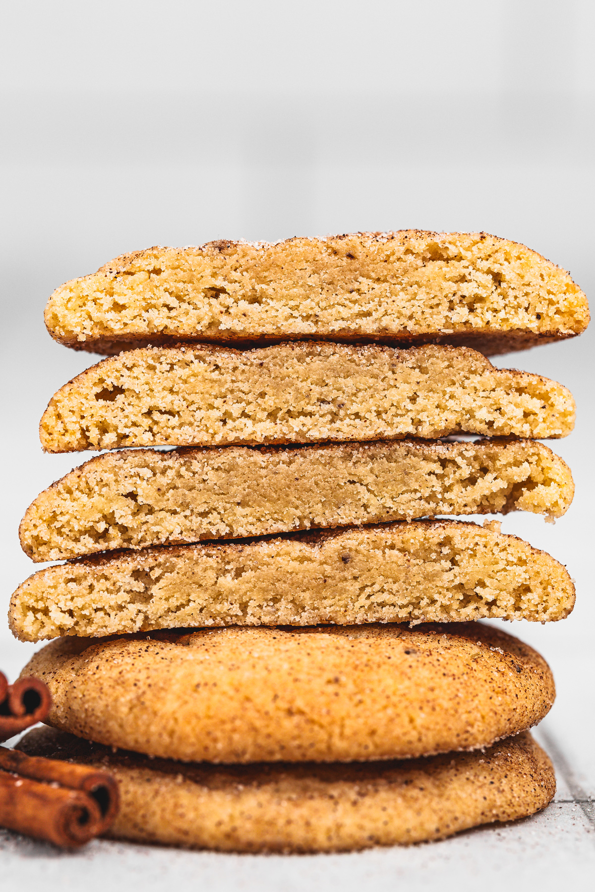 Chewy snickerdoodles broken in half showing inside texture