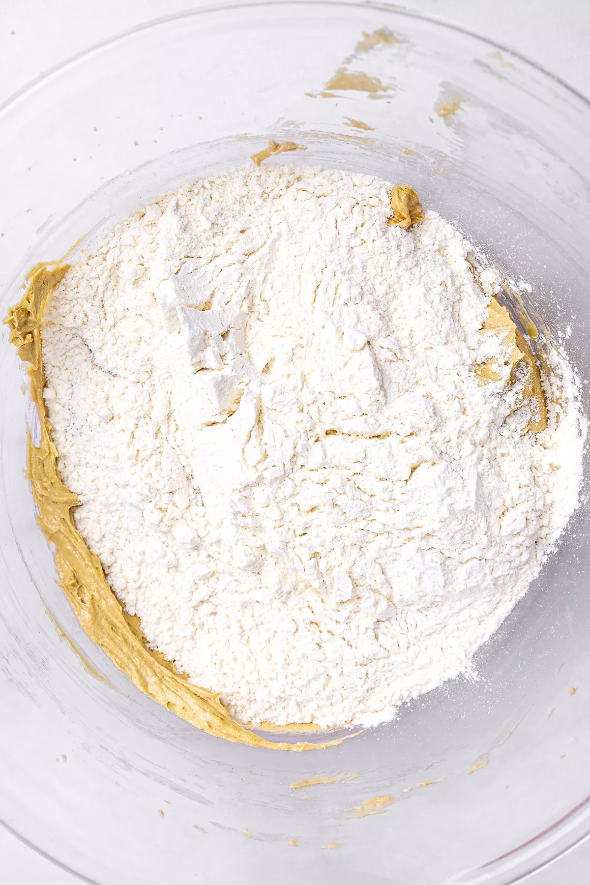 Bowl with white chocolate pistachio cookies dough and dry ingredients