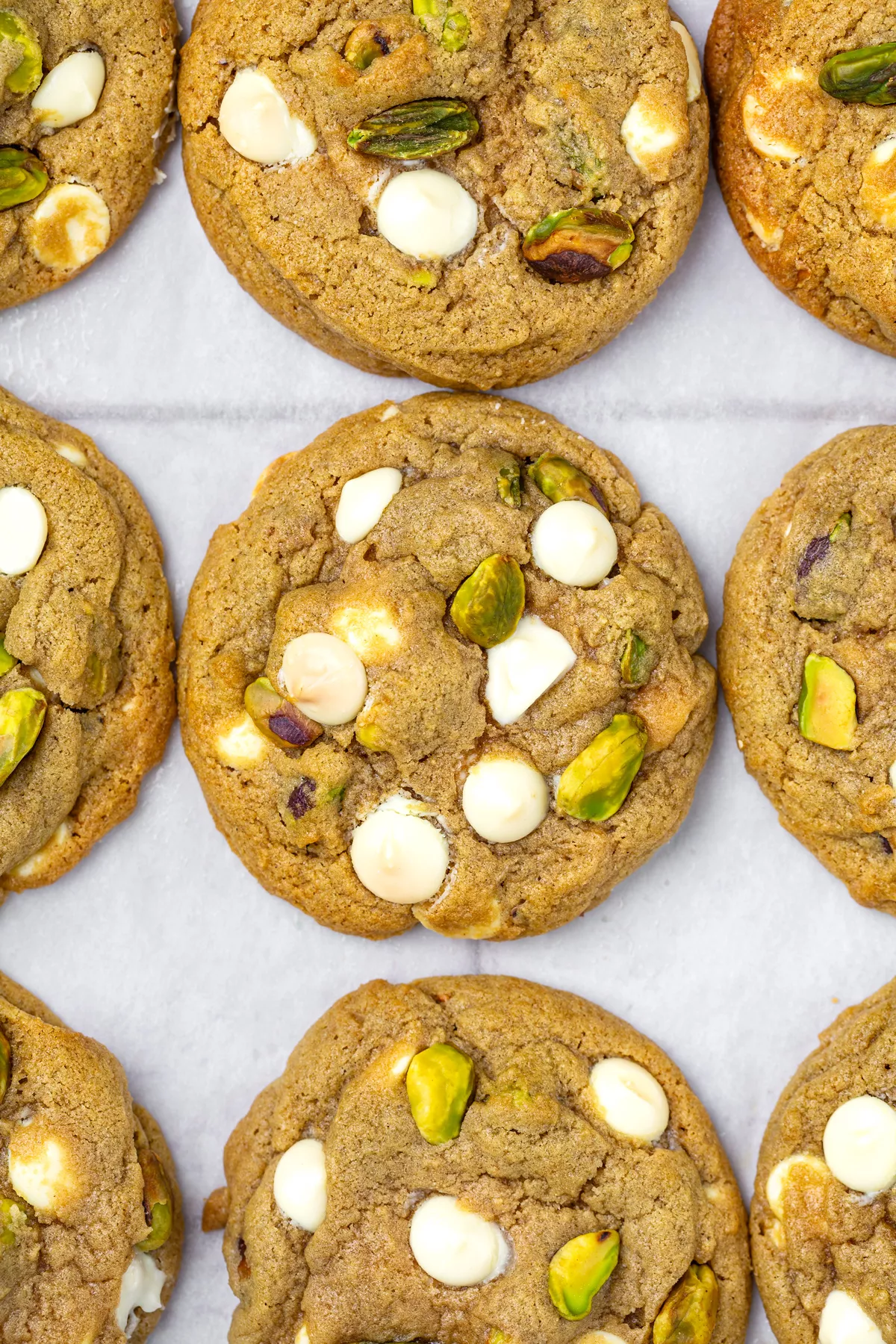 Freshly baked white chocolate pistachio cookies on a tray
