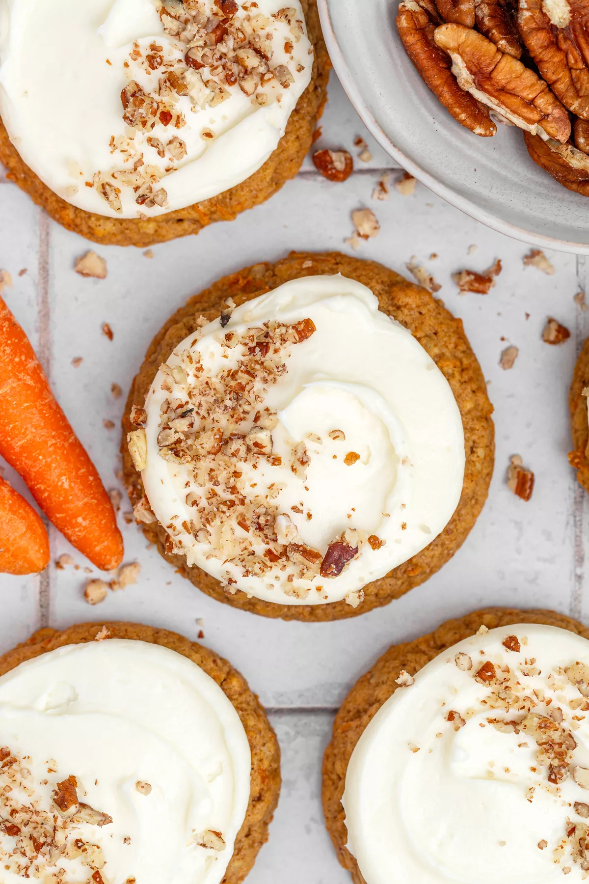 Carrot cake cookies with cream cheese frosting on a table
