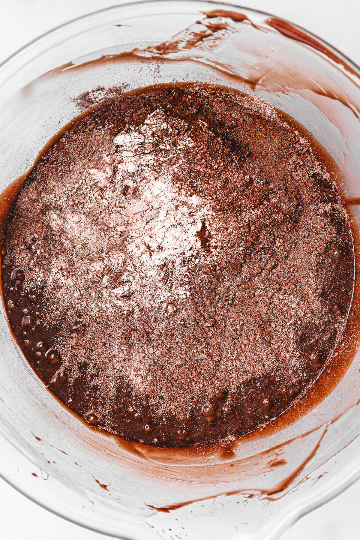 Brownie batter with dry ingredients added in mixing bowl
