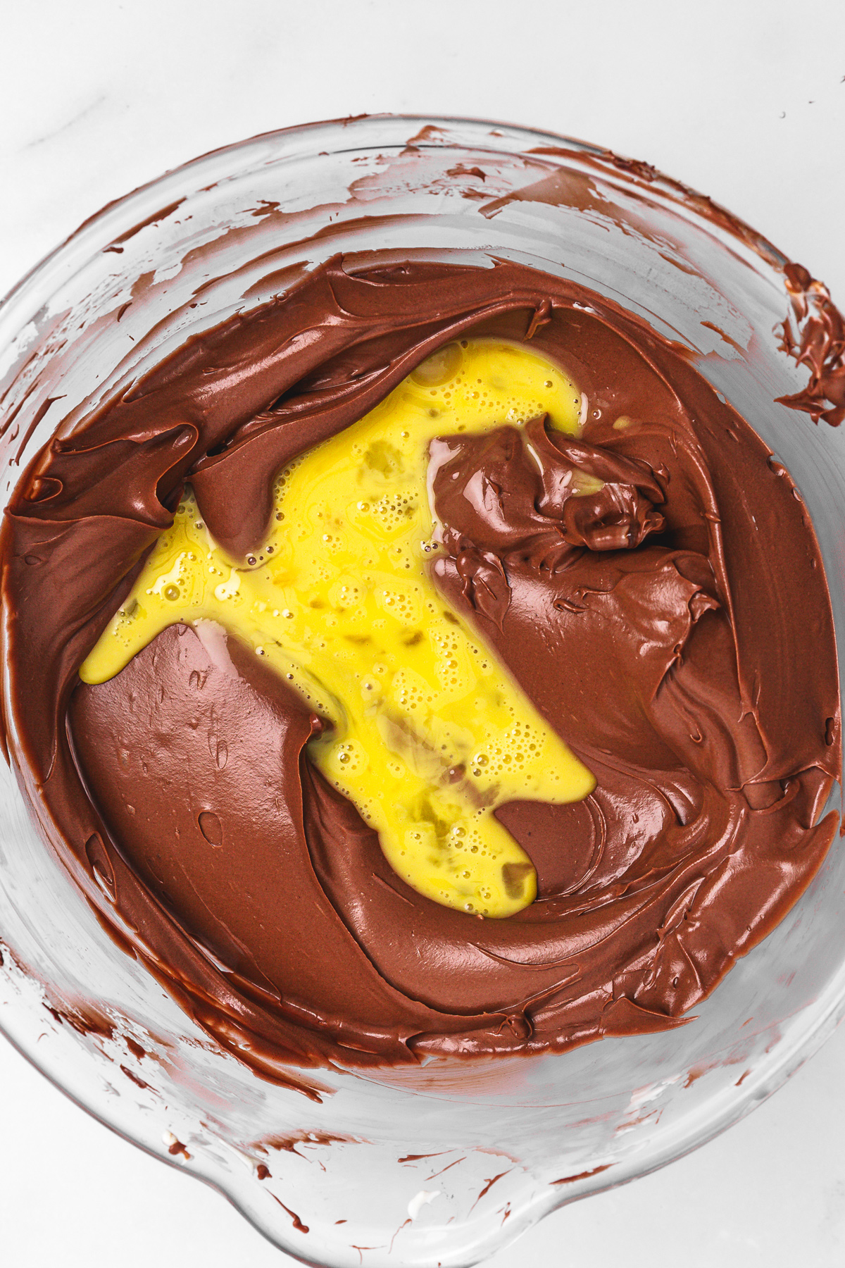 Nutella cheesecake batter with eggs mixed in