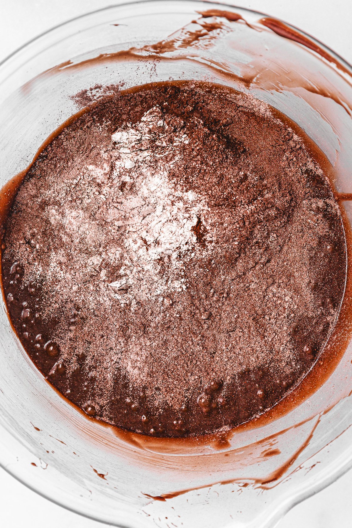 Brownie batter with dry ingredients added in mixing bowl