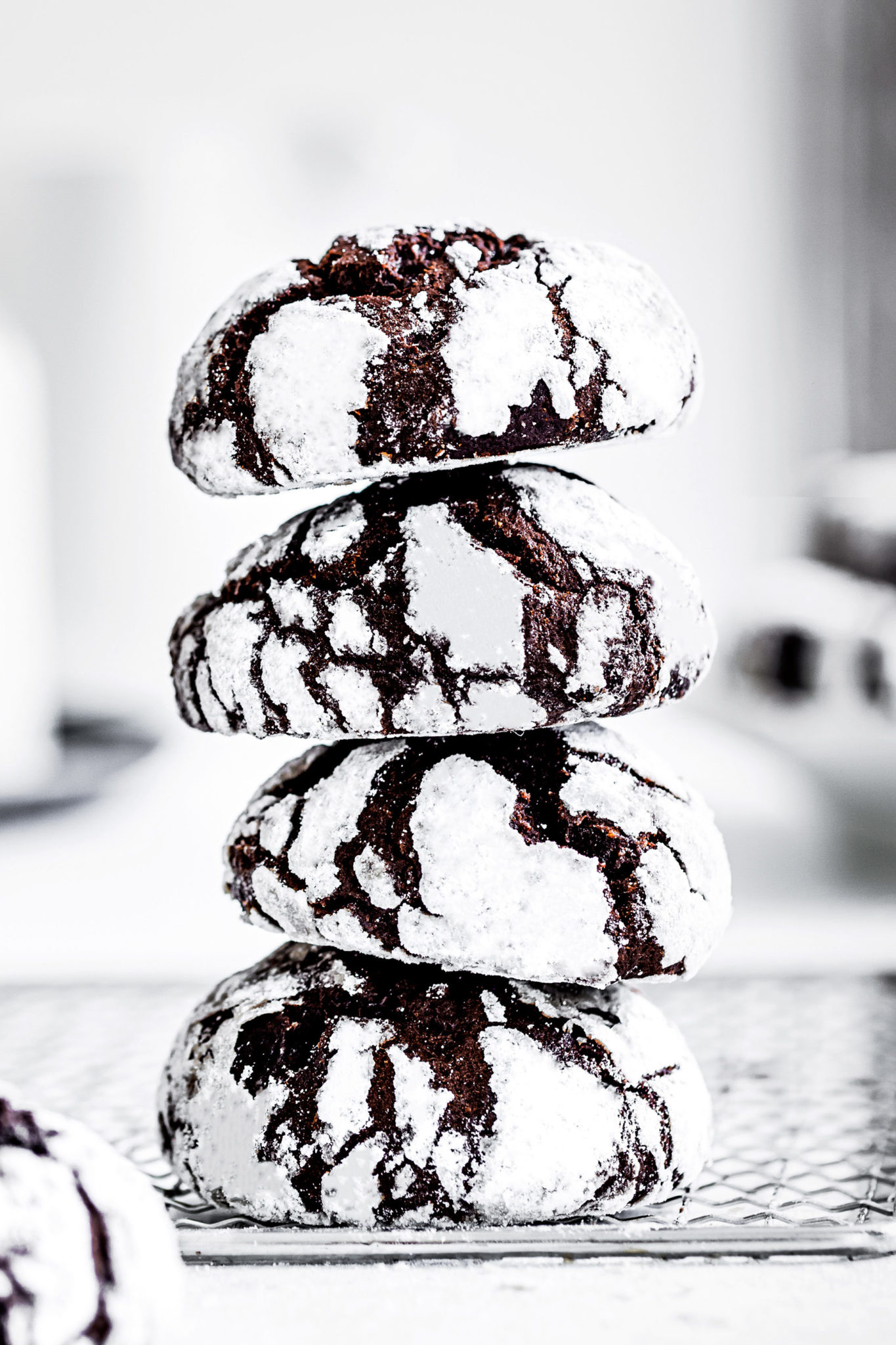 Stacked chocolate crinkle cookies on a table