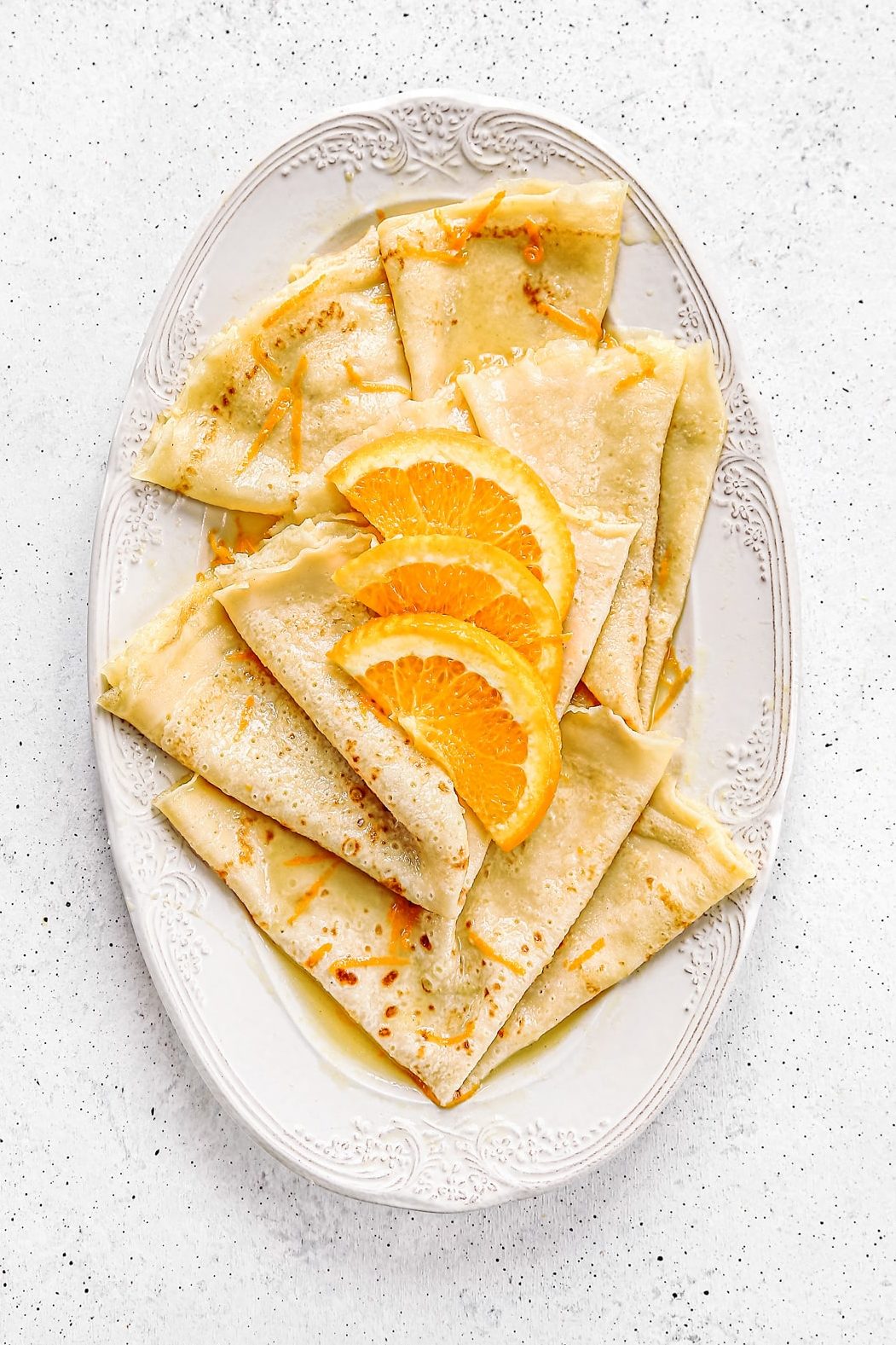 crepes suzette plated with orange juice butter sauce