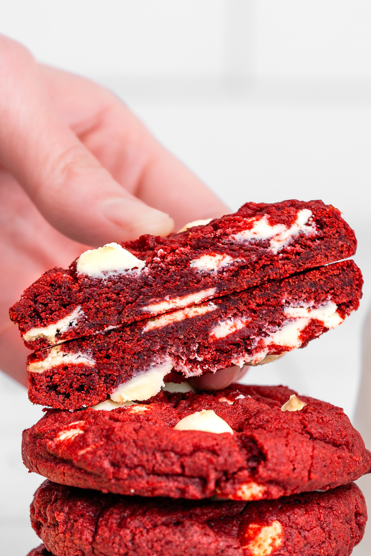 broken red velvet cookie showing the soft center