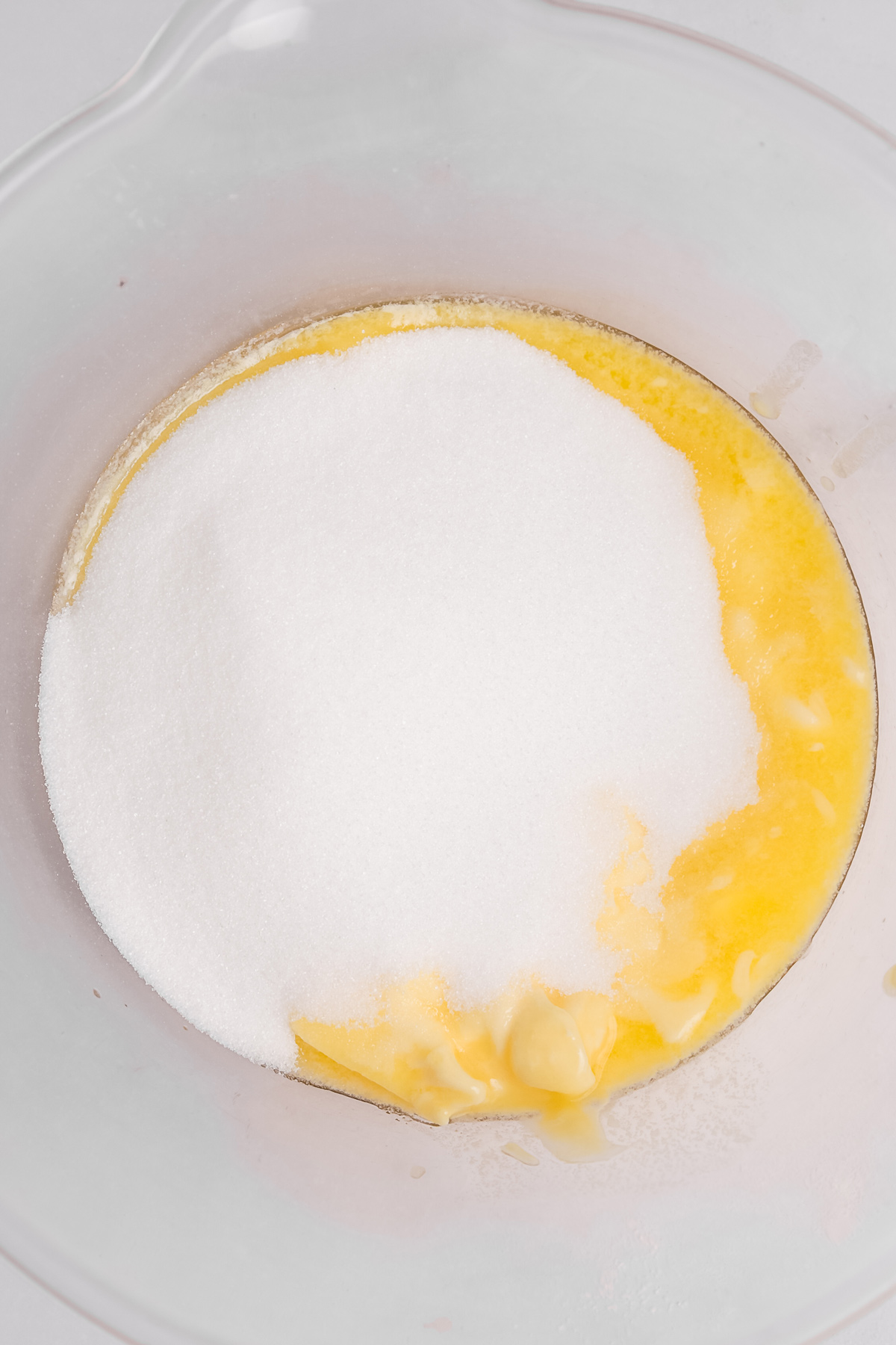 mixing softened butter and sugar in a bowl