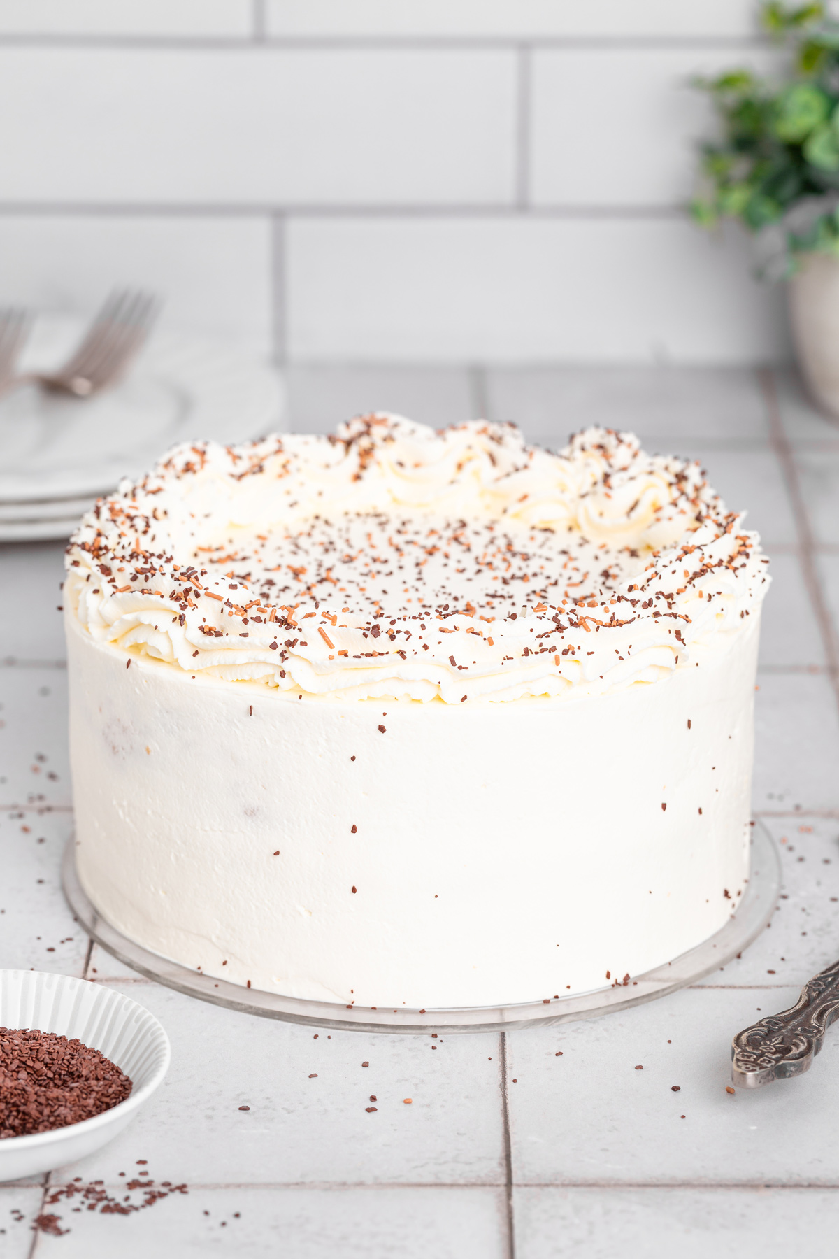 finished vanilla cake on a table with smooth frosting