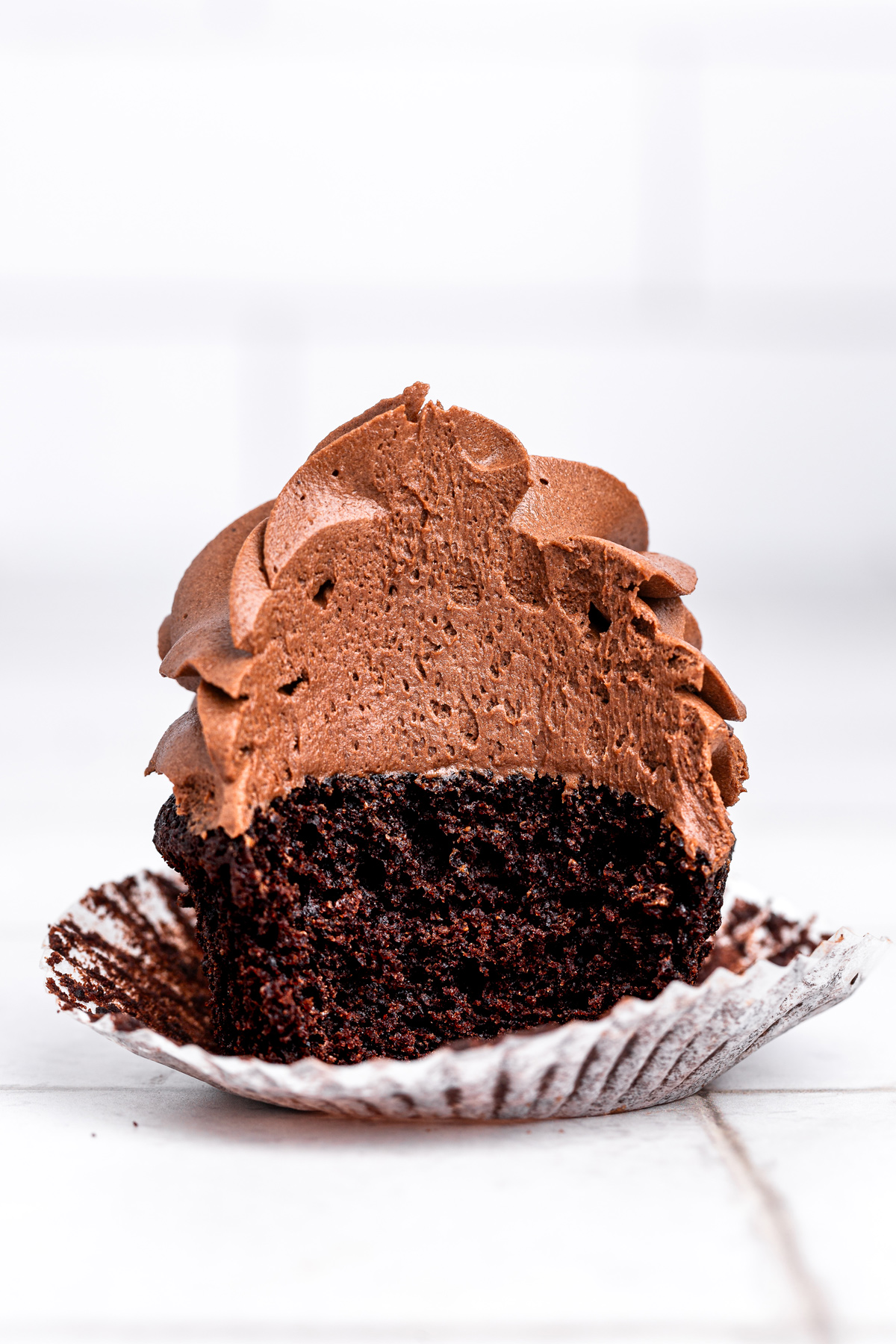 bitten chocolate cupcake showing soft chocolate crumb