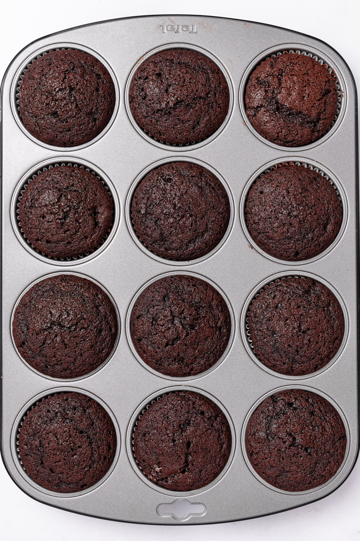baked chocolate cupcakes in a muffin pan