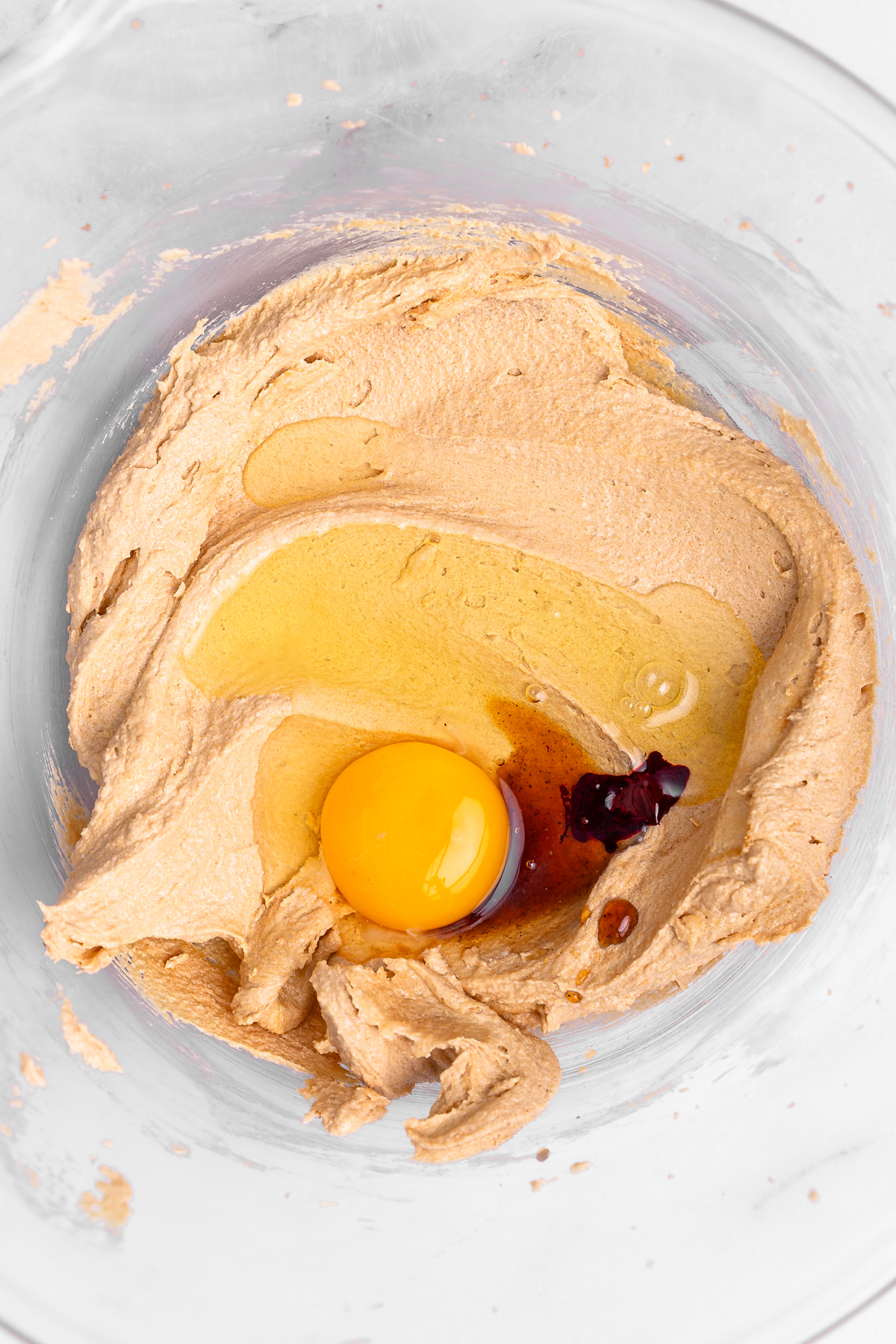 mixing butter sugar egg vanilla and red food coloring for red velvet cookies