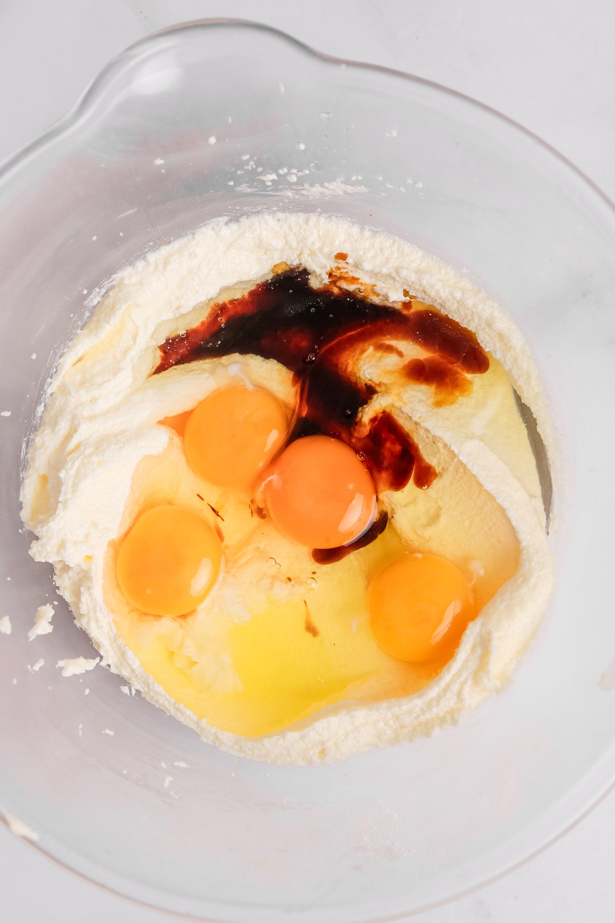 mixing eggs vanilla and creamed butter in a bowl