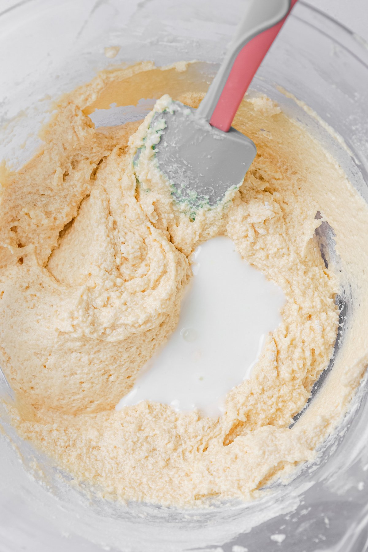 mixing bowl with cupcakes batter and buttermilk