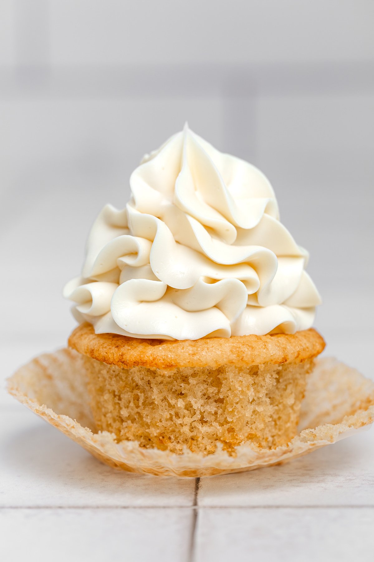 Swiss meringue buttercream frosting pipped on a cupcake