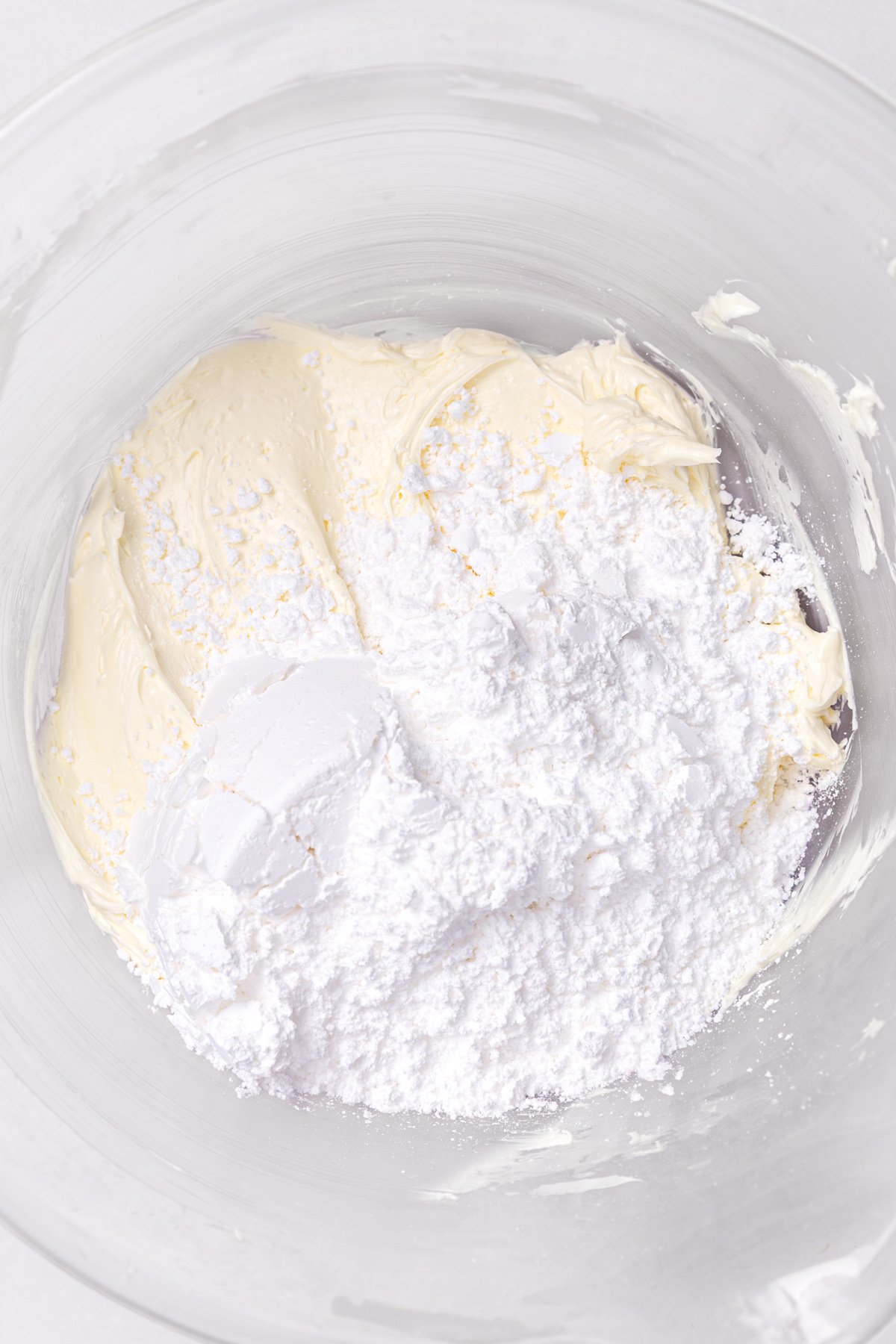 butter and powdered sugar mixing for buttercream frosting