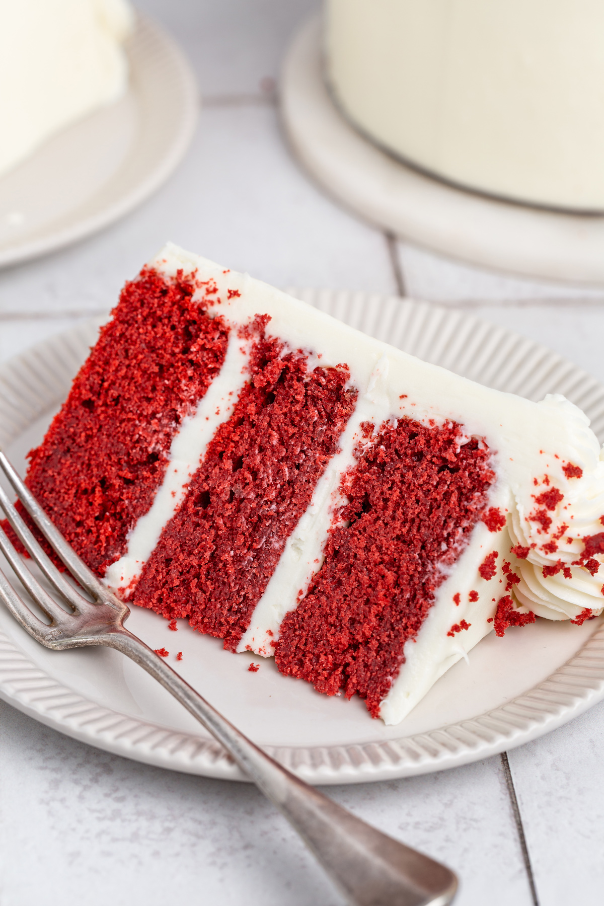 slice of red velvet layer cake on a plate