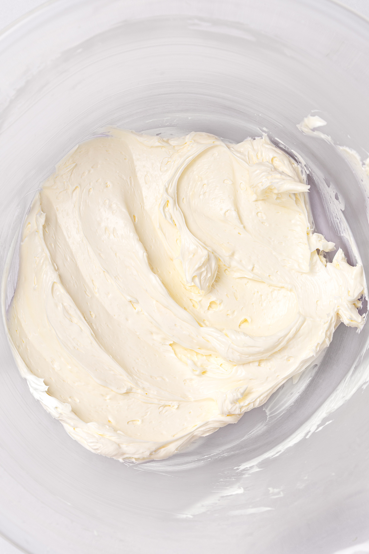 butter whipped for white chocolate buttercream frosting in mixing bowl