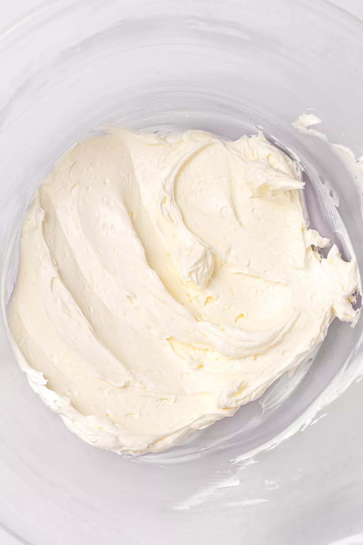 butter whipped for white chocolate buttercream frosting in mixing bowl
