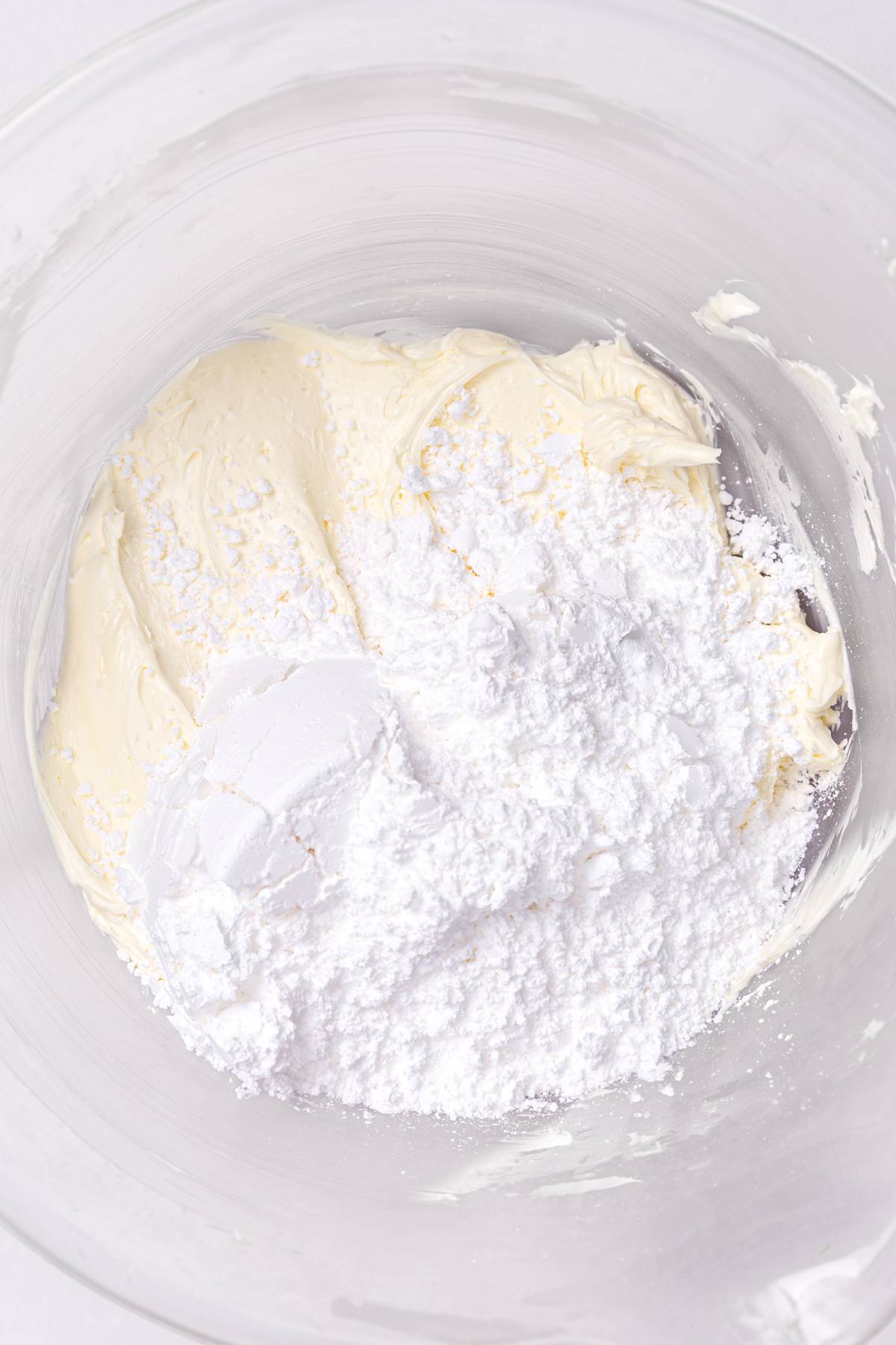butter and powdered sugar mixed for white chocolate buttercream frosting
